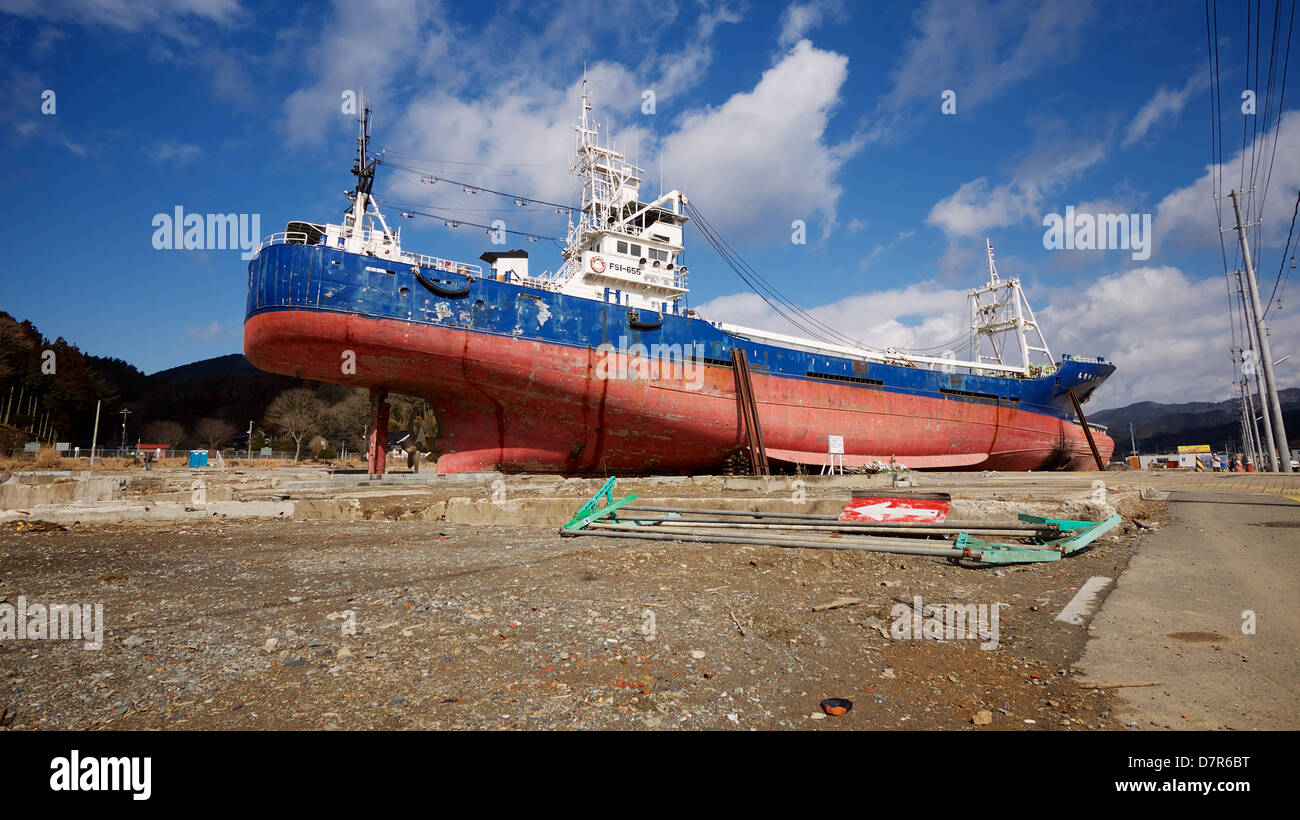 Fishing boat stranded inland after being washed ashore by the 2011 Tohoku Great Earthquake and Tsunami at the port of Kesennuma. Stock Photo