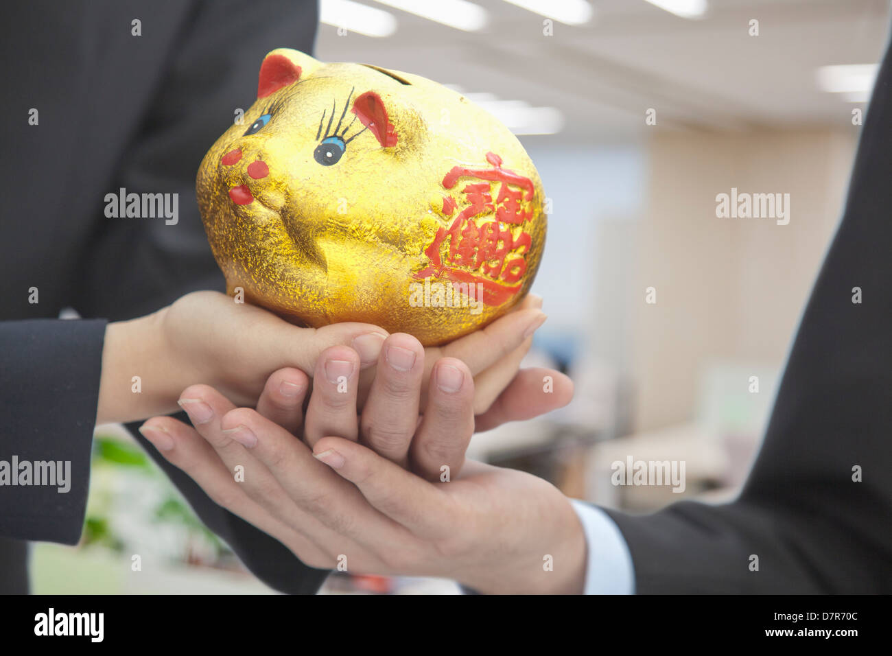 Holding Chinese Gold Piggy Bank Stock Photo Alamy
