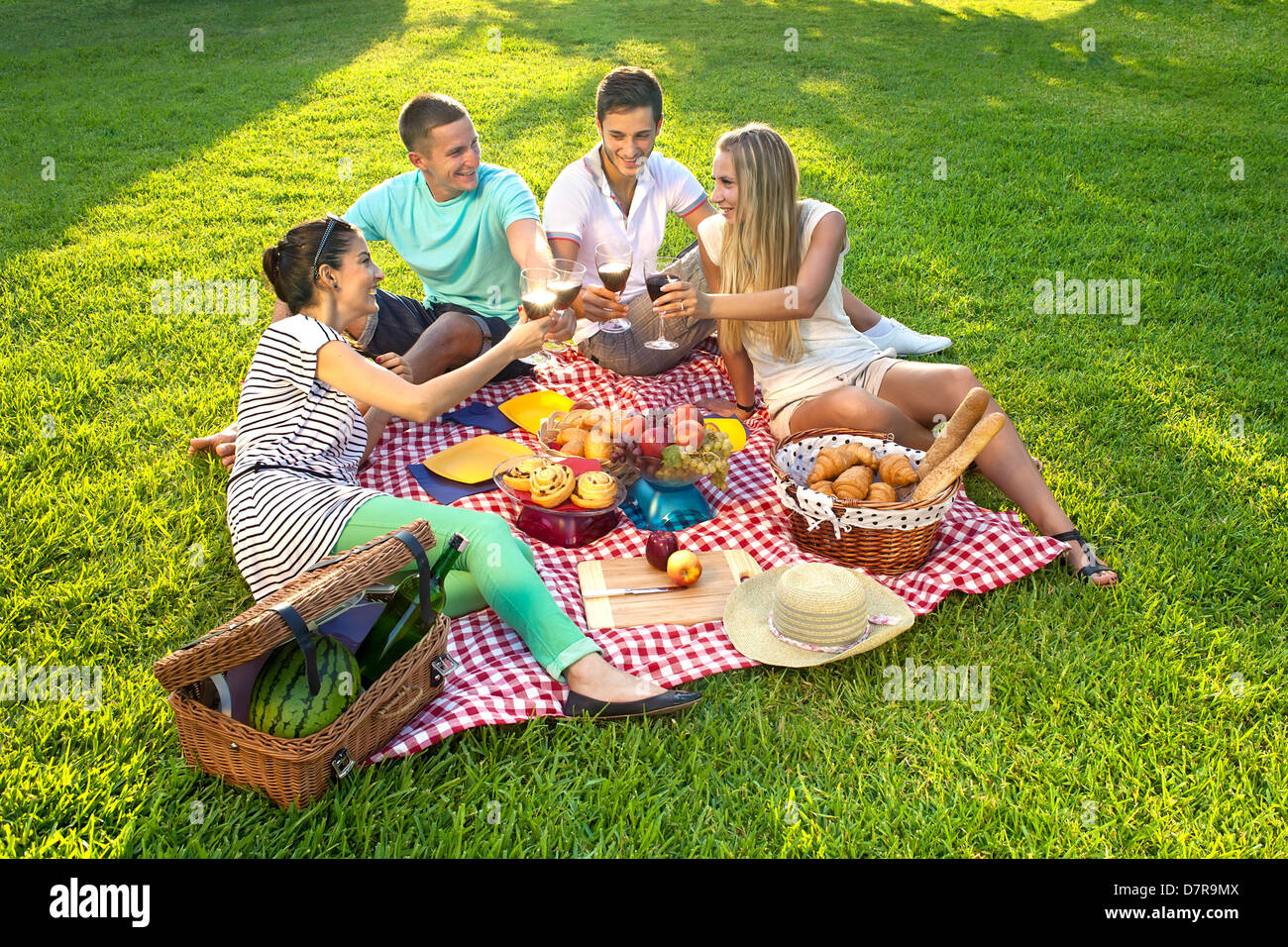 Group of friends having picnic in park hi-res stock photography and ...