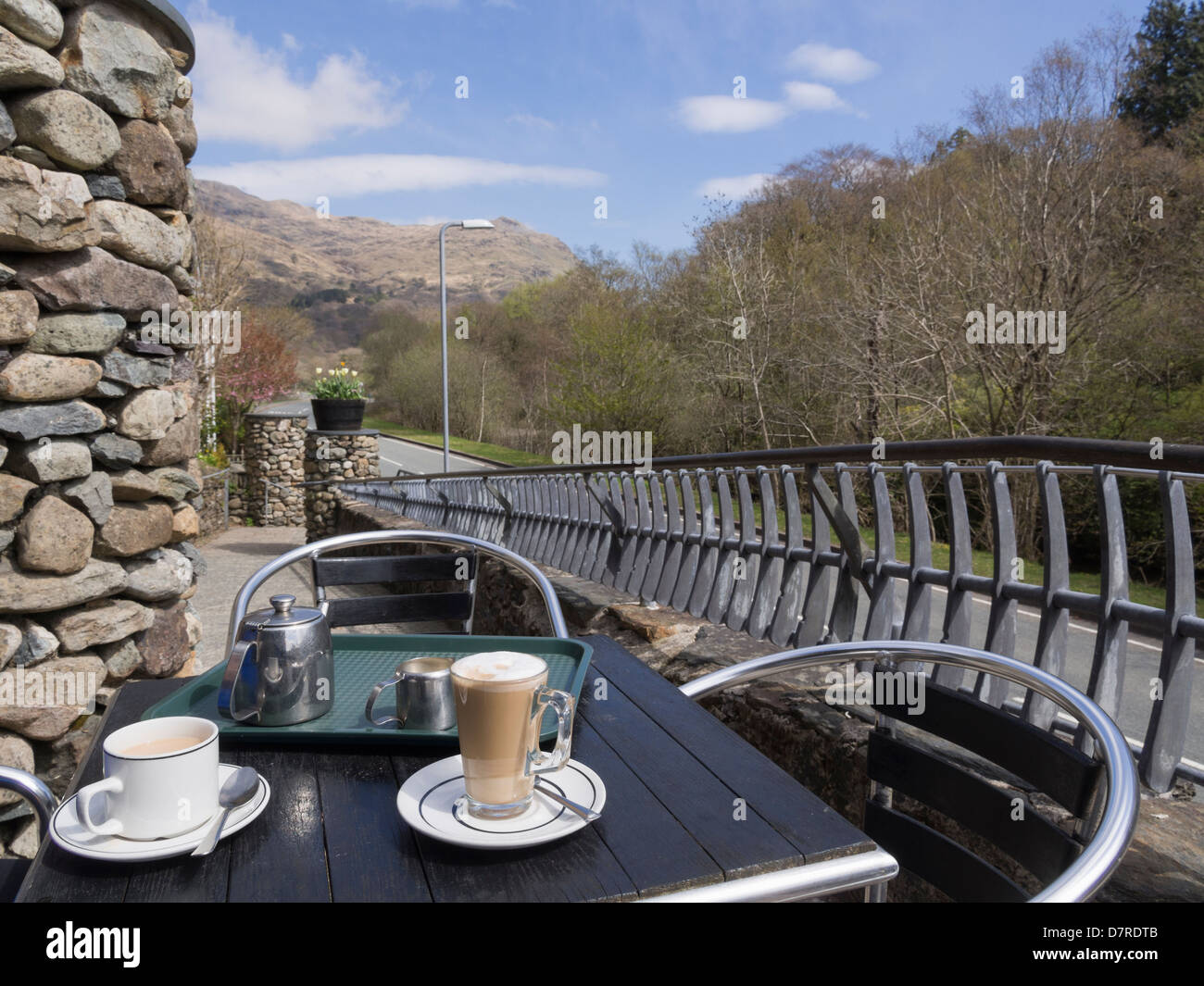 Table and chairs with tea and coffee cups outside Café Gwynant in Nantgwynant Valley in Snowdonia National Park, North Wales, UK Stock Photo