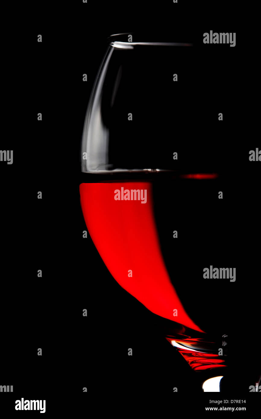half of red wine glass isolated on black background Stock Photo - Alamy
