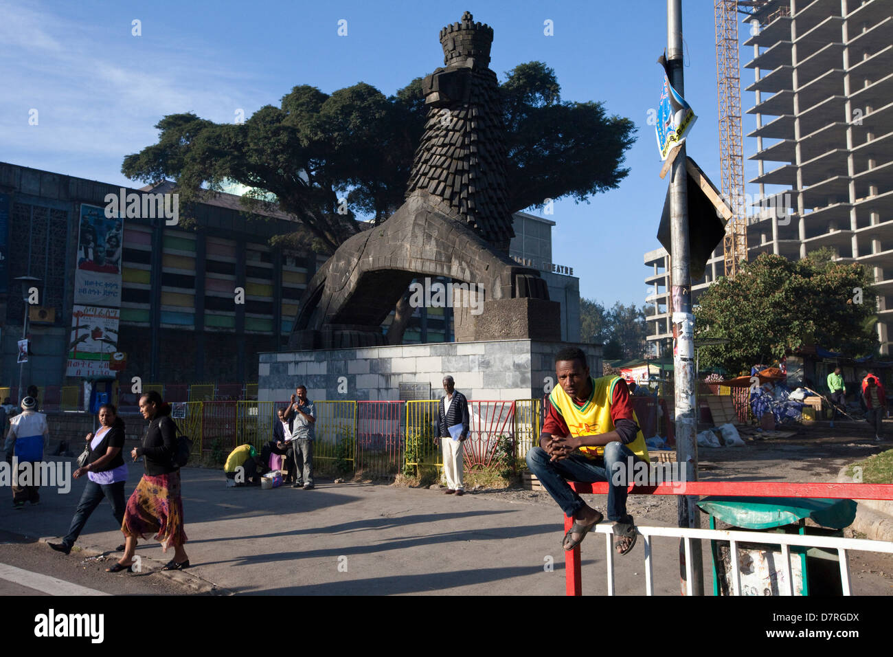 A man sits beneath a Lion of Judah statue outside the National Theatre, Addis Ababa, Ethiopia. Stock Photo