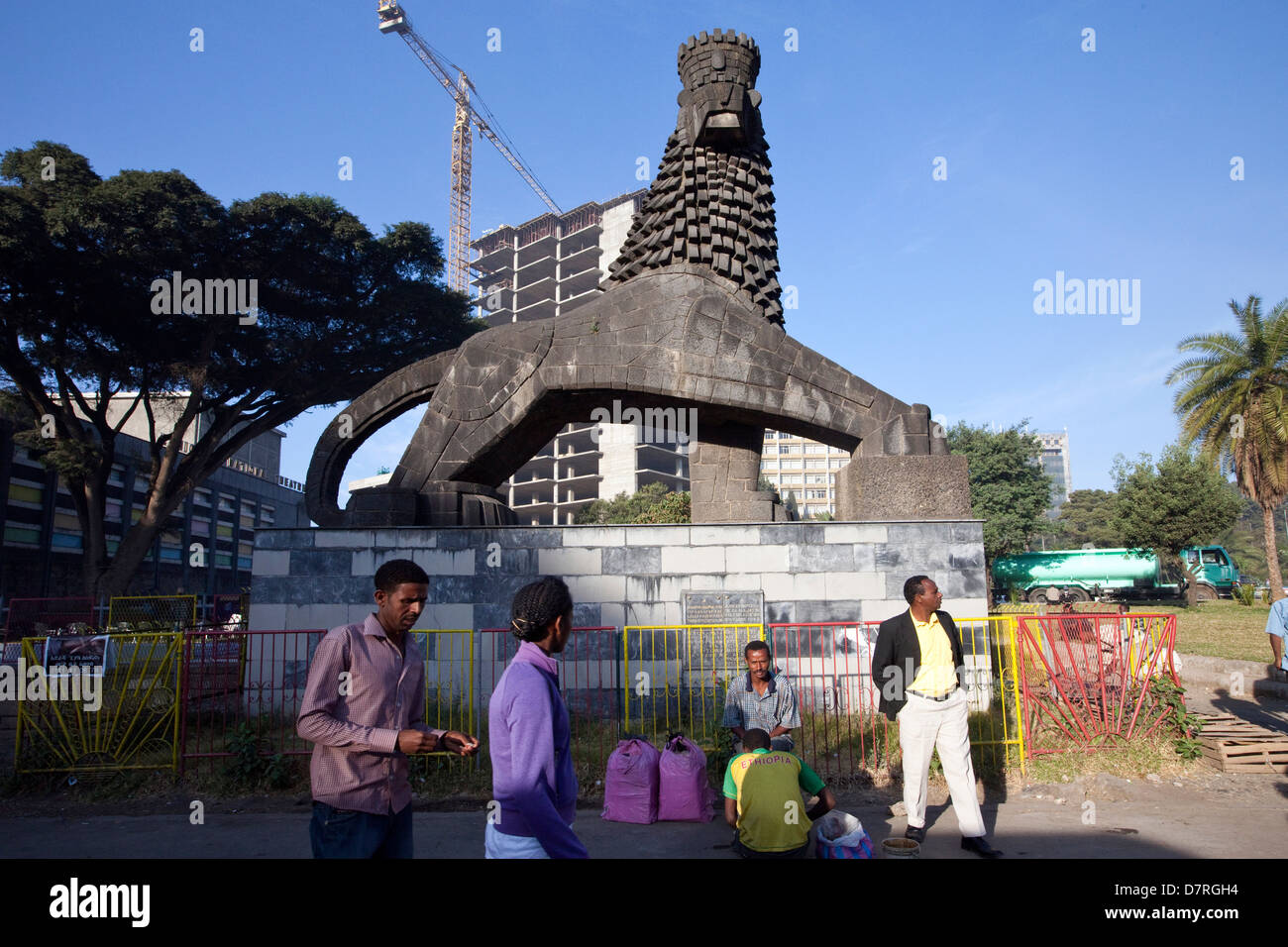 A man sits beneath a Lion of Judah statue outside the National Theatre, Addis Ababa, Ethiopia. Stock Photo