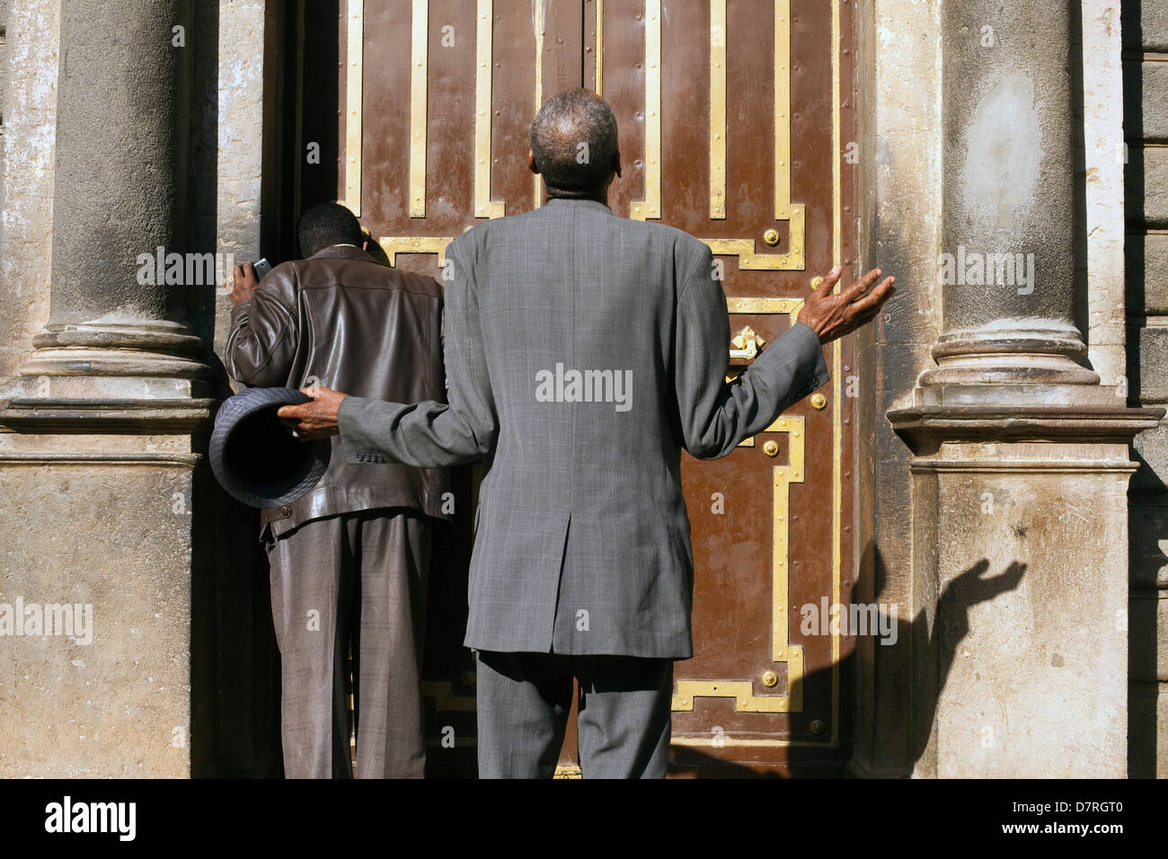 Men worshipping outside St George's Cathedral in Addis Ababa, Ethiopia Stock Photo