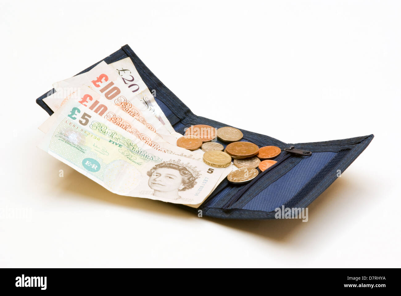 UK coins spilling from wallet on to UK bank notes Stock Photo