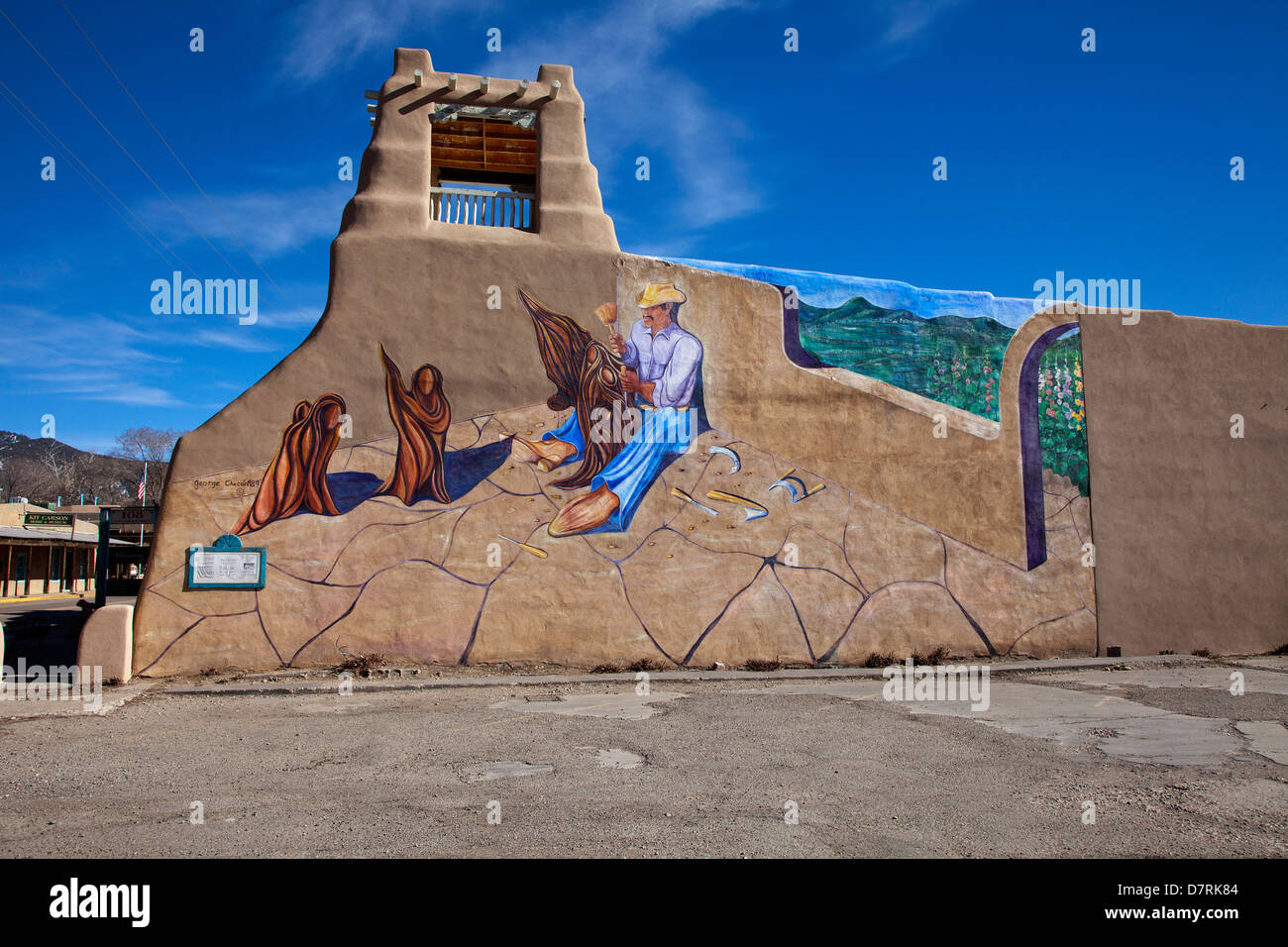 A mural entitled 'El Santero' by George Chacon adorns a building along Kit Carson Street in Taos, New Mexico. Stock Photo