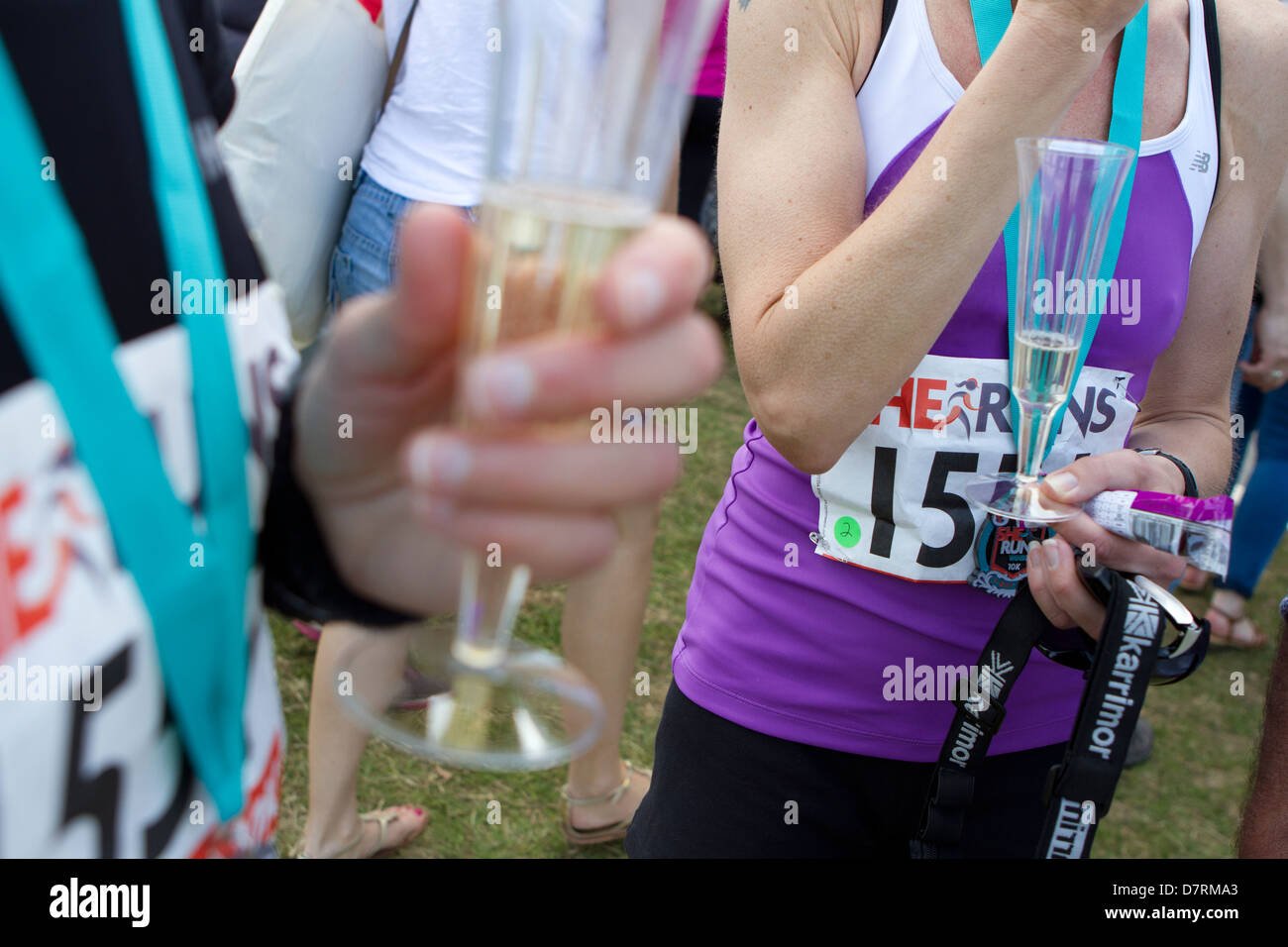 Finishers of She Runs Windsor celebrate with champagne. Stock Photo