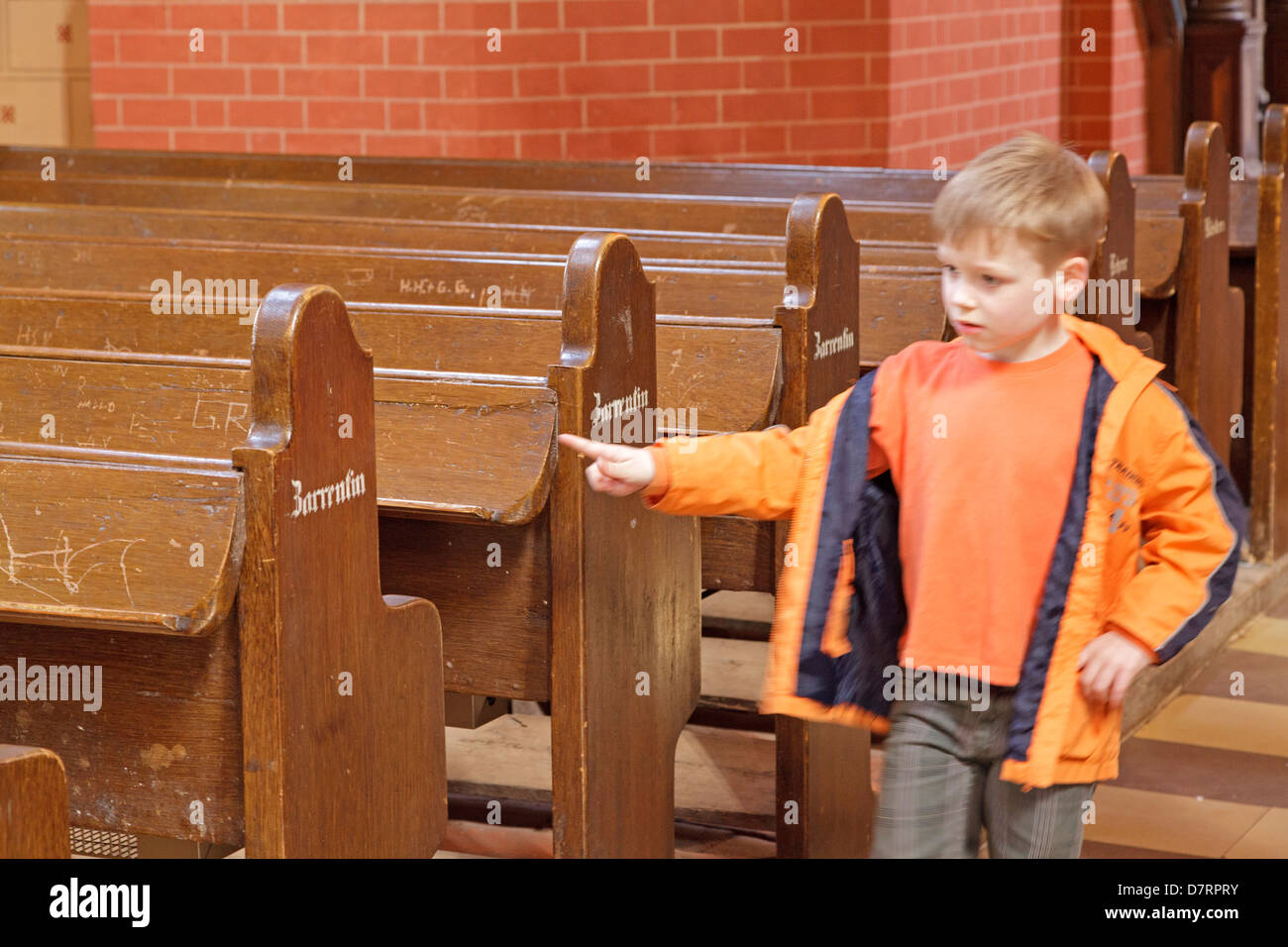 young boy counting the benches inside the church, Zarrentin, Mecklenburg-West Pomerania, Germany Stock Photo