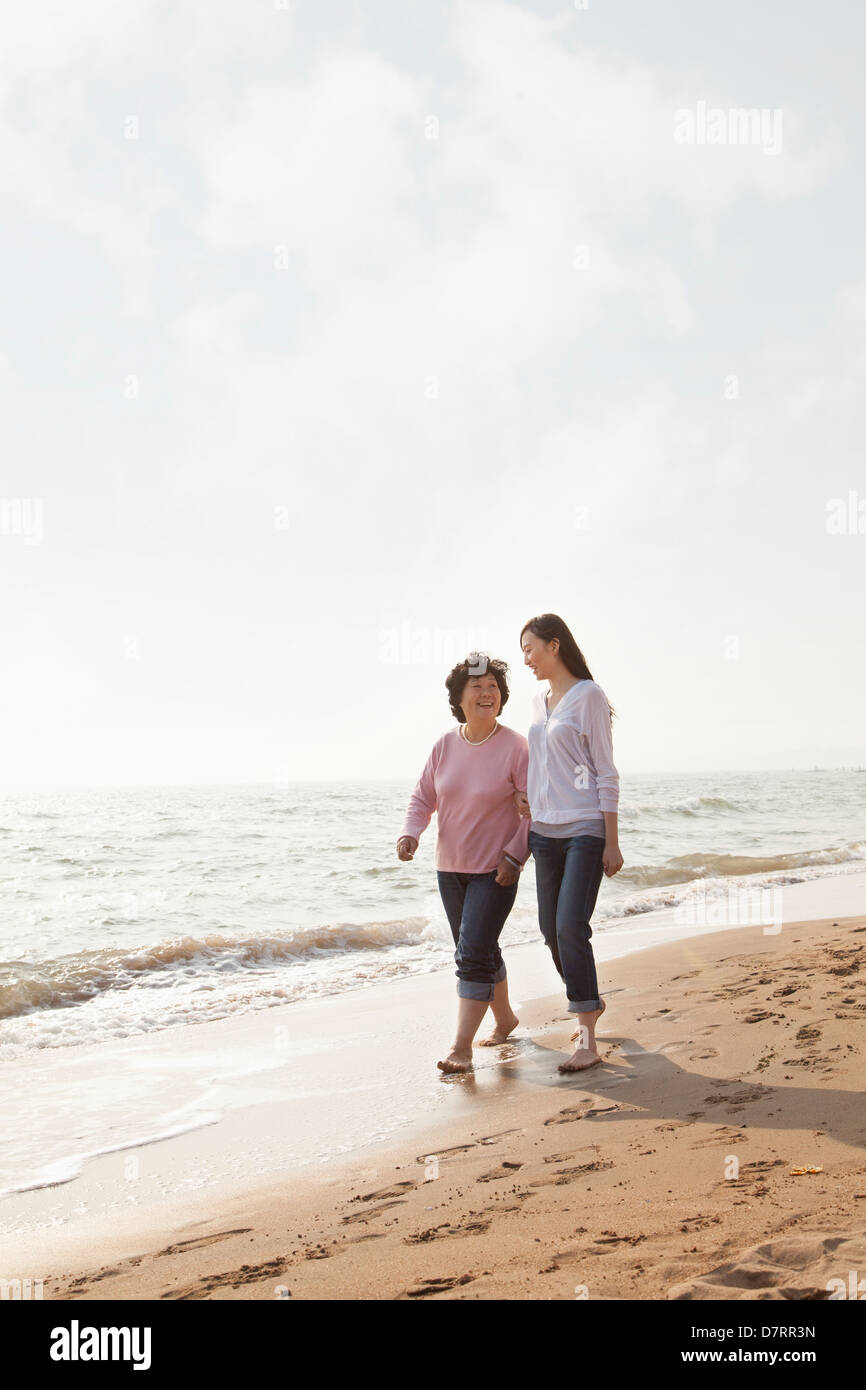 Grandmother and Granddaughter Taking a Walk by the Beach Stock Photo