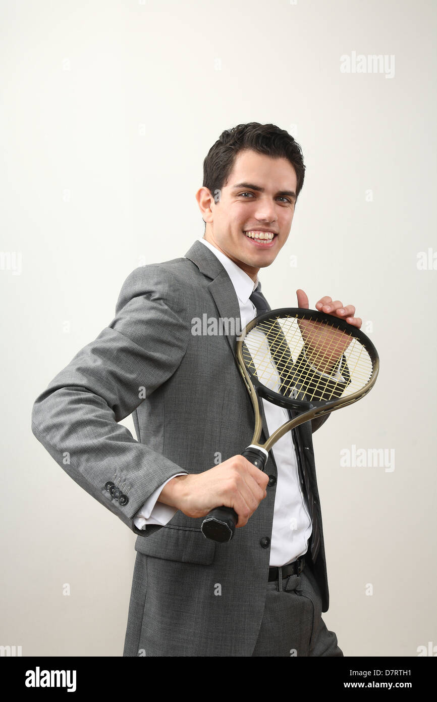 Man Using Tennis Racket young business man with tennis racket Stock Photo - Alamy