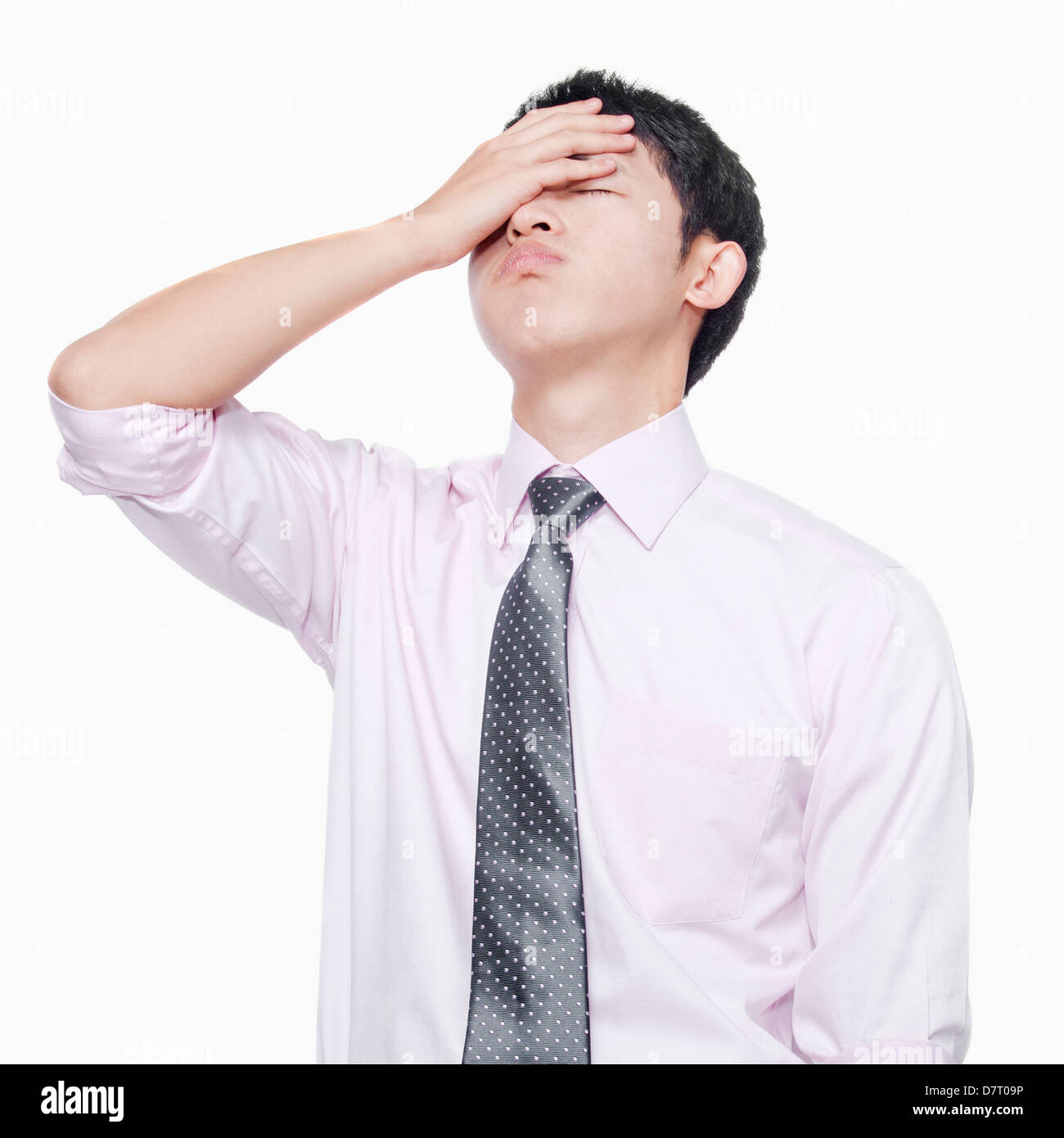 Young man with hand on forehead Stock Photo