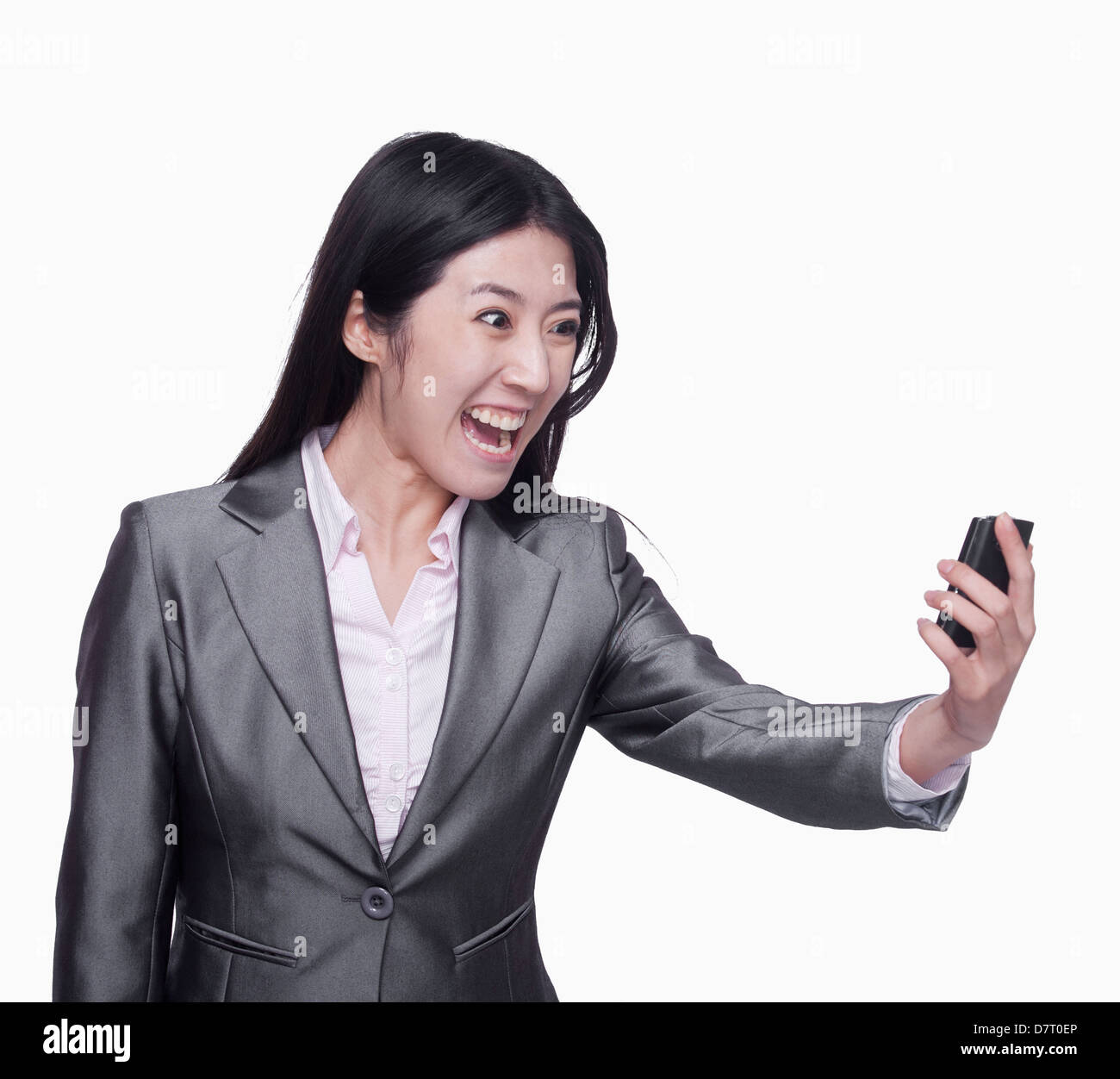 Businesswoman yelling at mobile phone Stock Photo