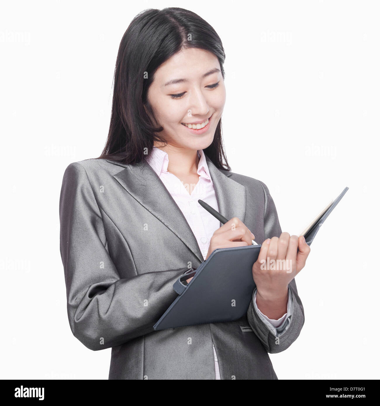 Businesswoman taking notes in her notebook Stock Photo