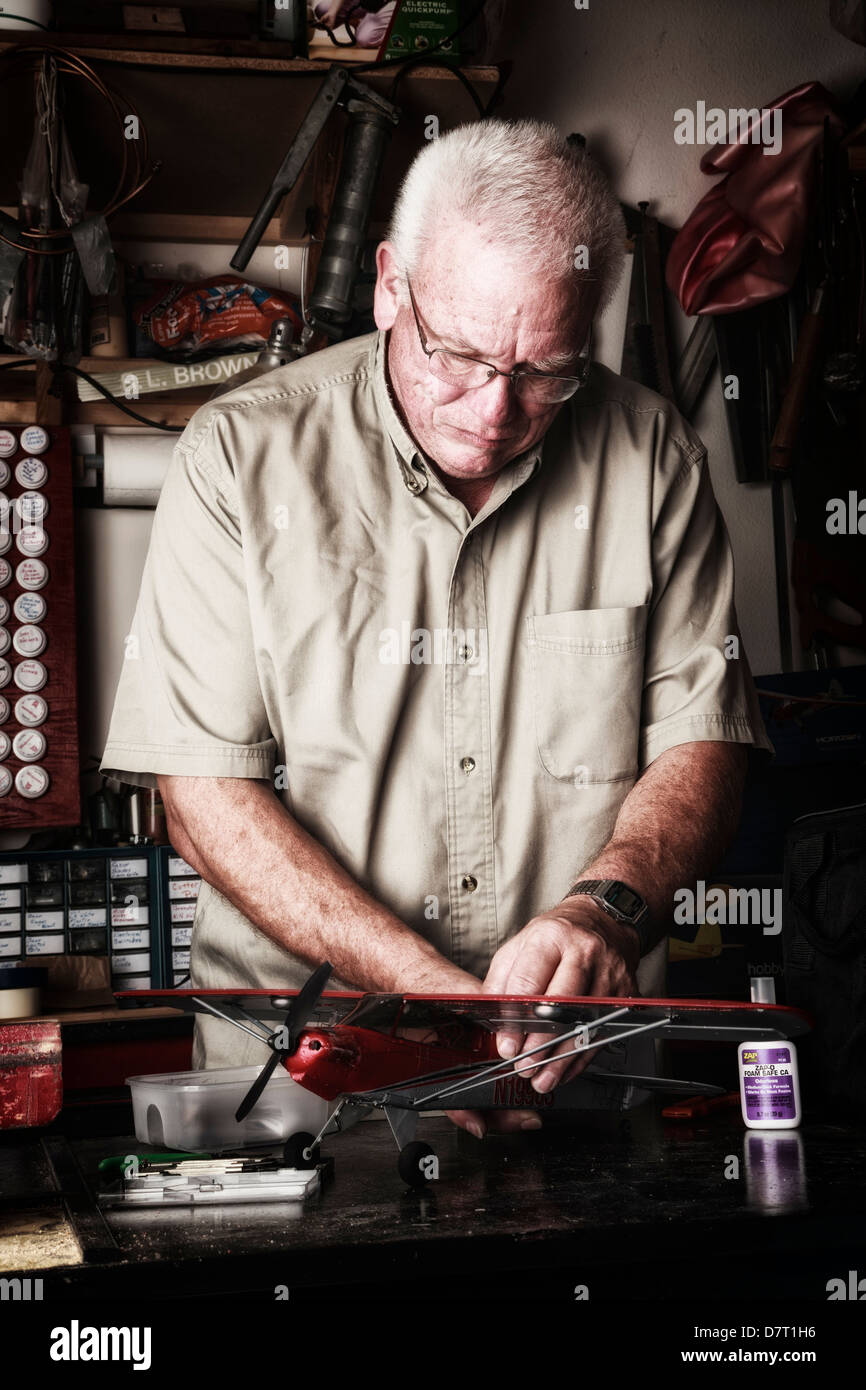 USA, Oregon, Keizer, retired man performing maintenance on his Parkzone