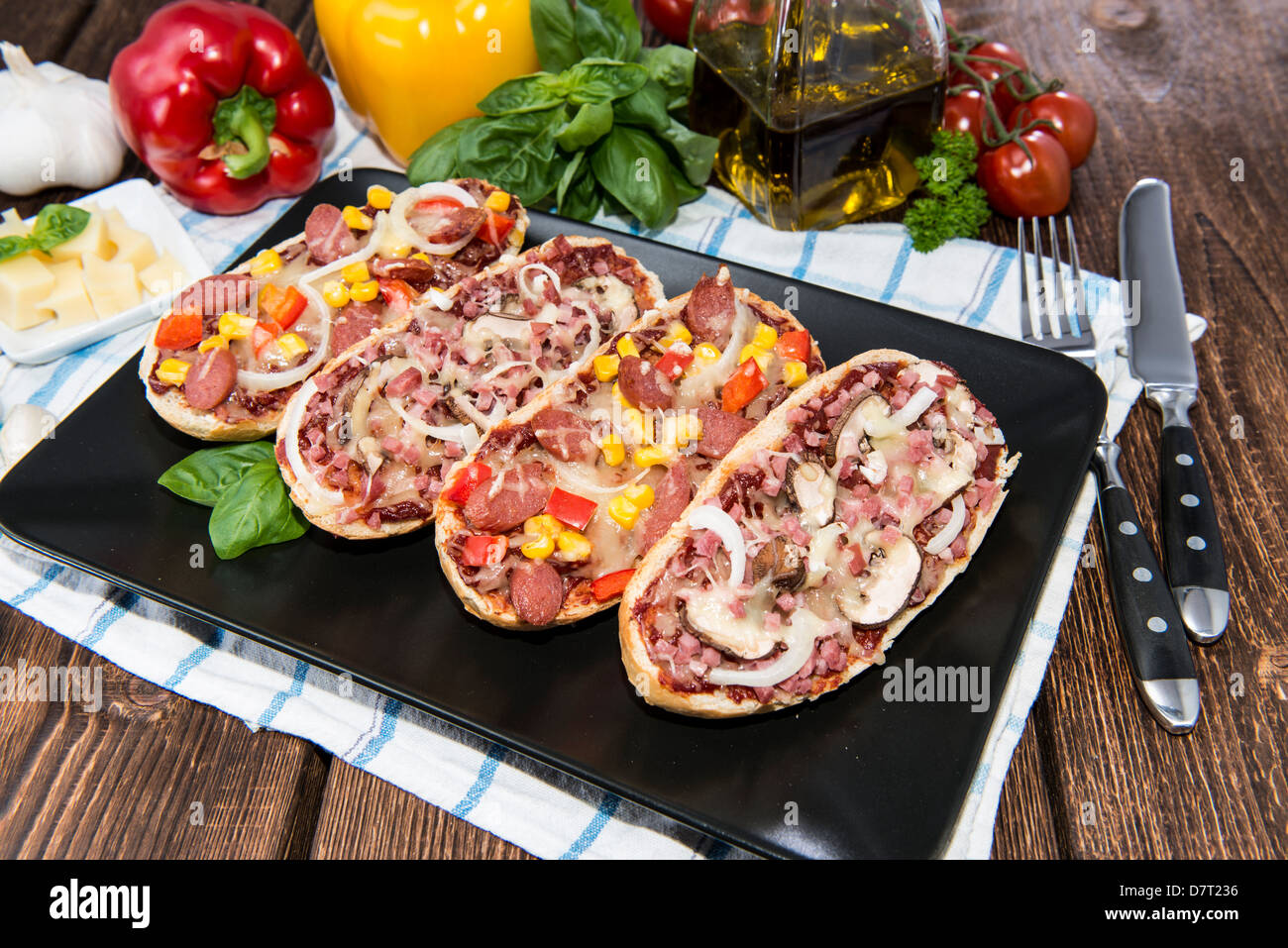 Fresh made Salami and Ham Pizza Baguettes on a plate Stock Photo Alamy