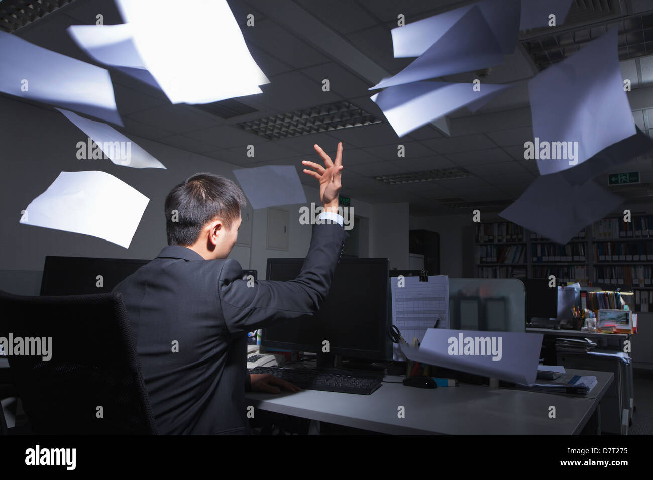 White-collar worker throwing white sheets in air in office Stock Photo