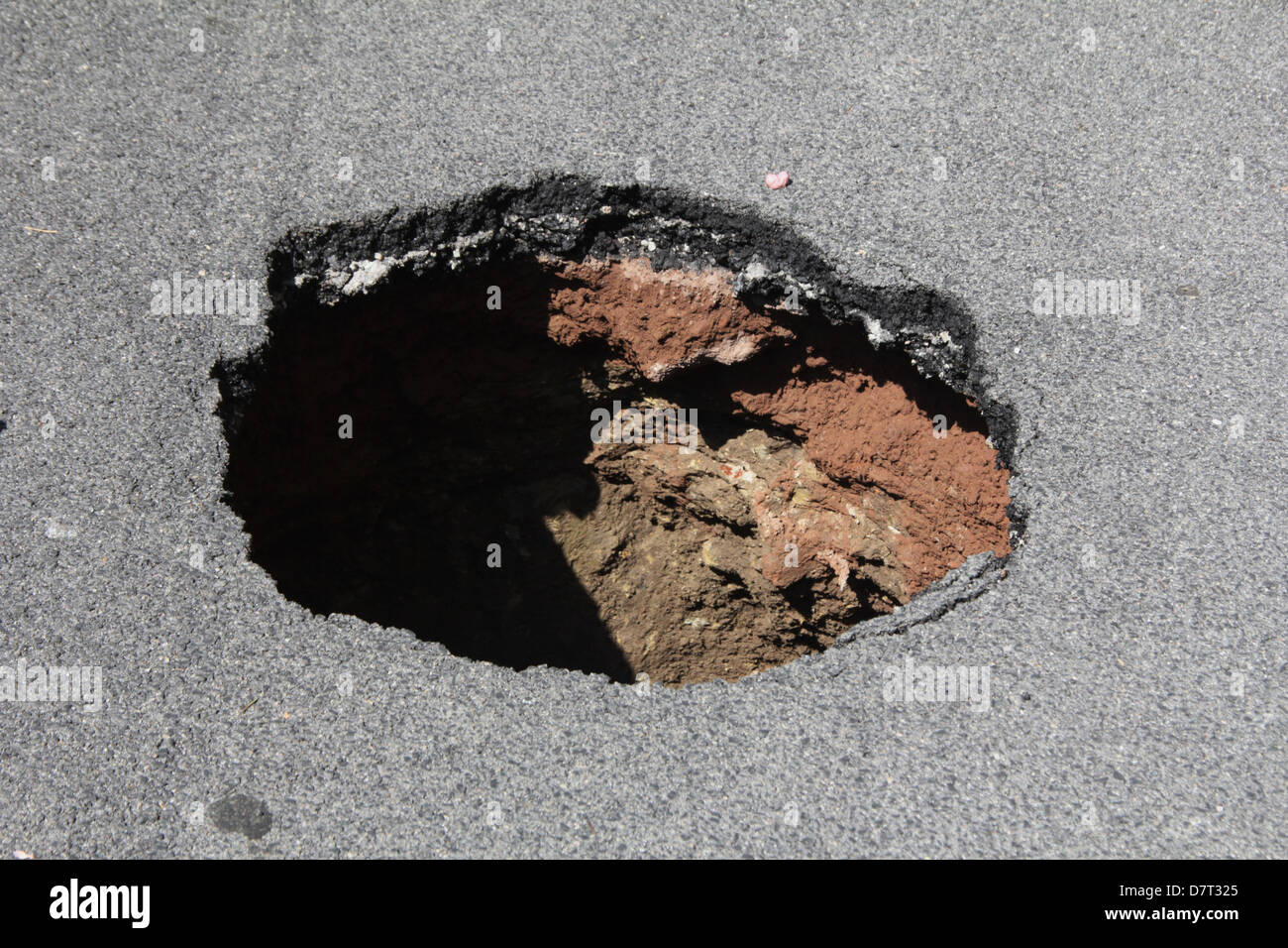 detail of hole in damaged road surface in city town Stock Photo