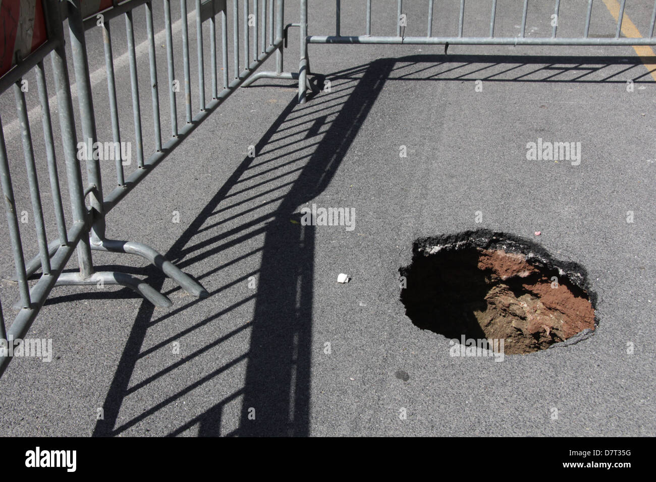 detail of hole in damaged road surface in city town Stock Photo