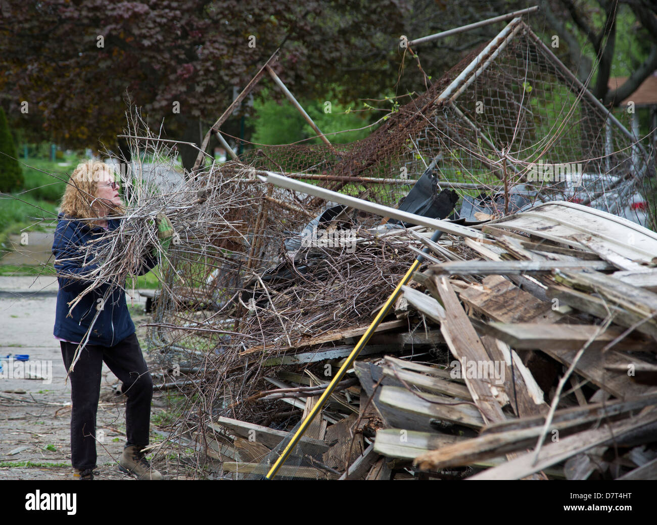 Volunteers from Chrysler Corp. and the Creekside neighborhood clean debris from vacant property in Detroit. Stock Photo