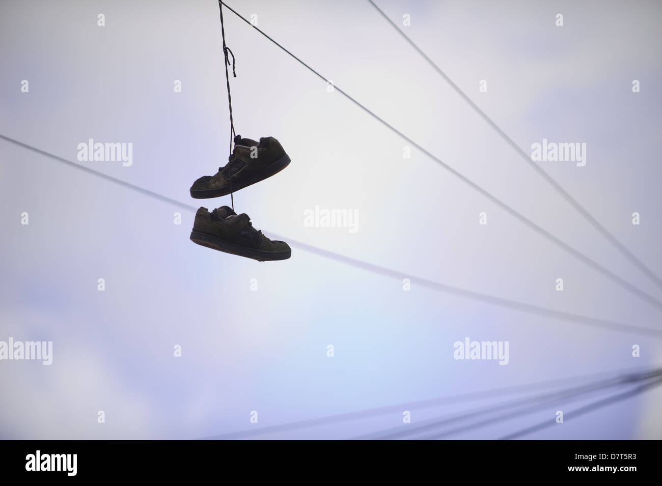 trainers hanging from telephone lines