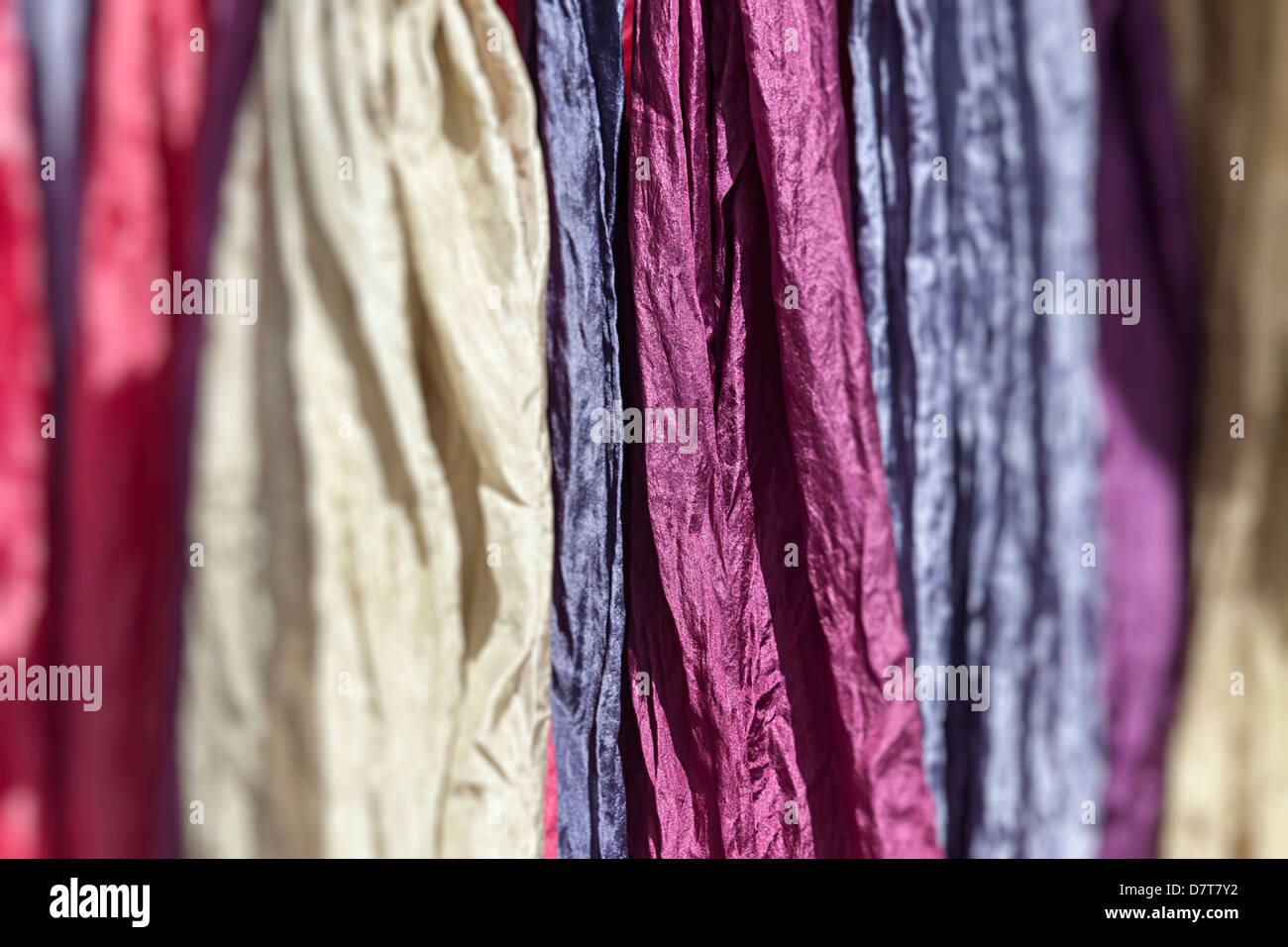 Silk scarves dyed using cochineal, Teguise market, Lanzarote, Canary Islands, Spain Stock Photo