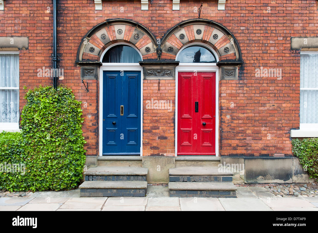 two original 18th doors side by side one red the other blue Stock Photo
