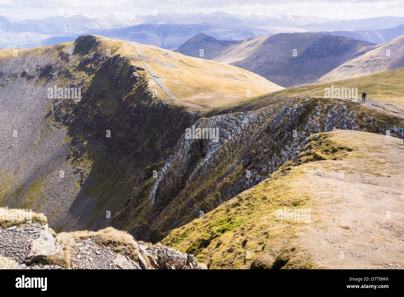 Hiker Walking towards Hobcarton Crags from Hopegill Head in the Lake District Stock Photo