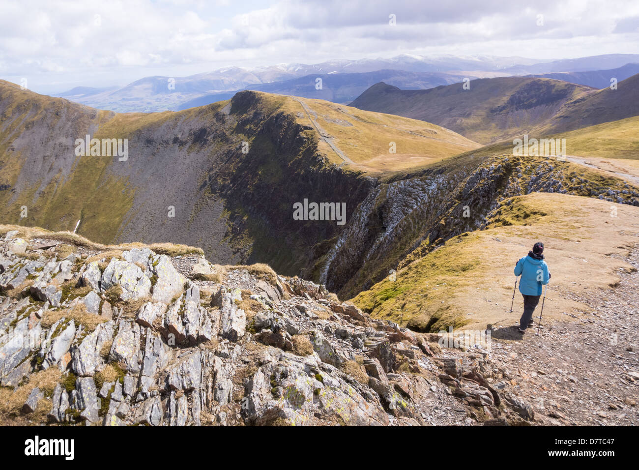 Hiker Walking towards Hobcarton Crags from Hopegill Head in the Lake District Stock Photo