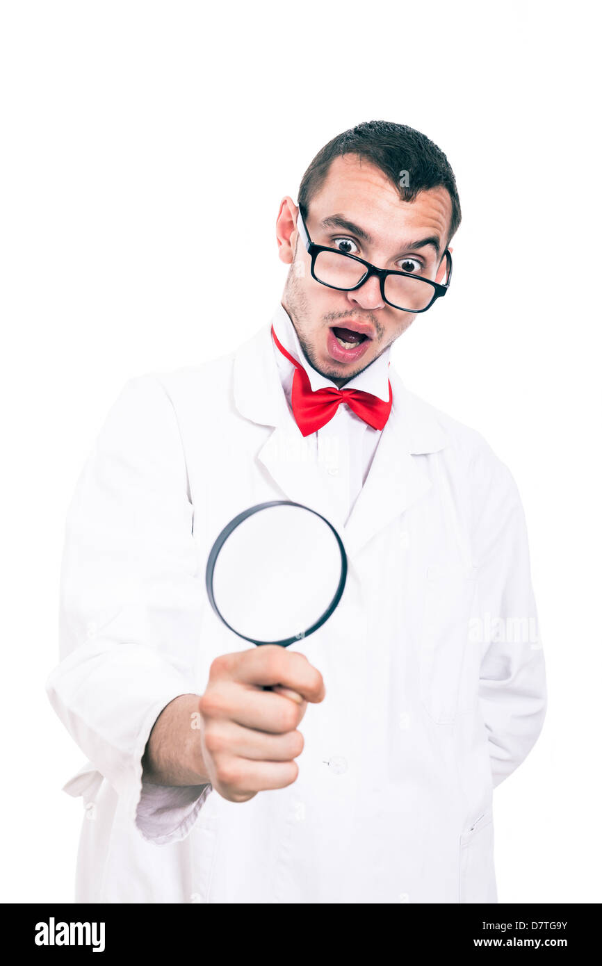 Shocked scientist in lab coat looking at magnifying glass, isolated on white background Stock Photo