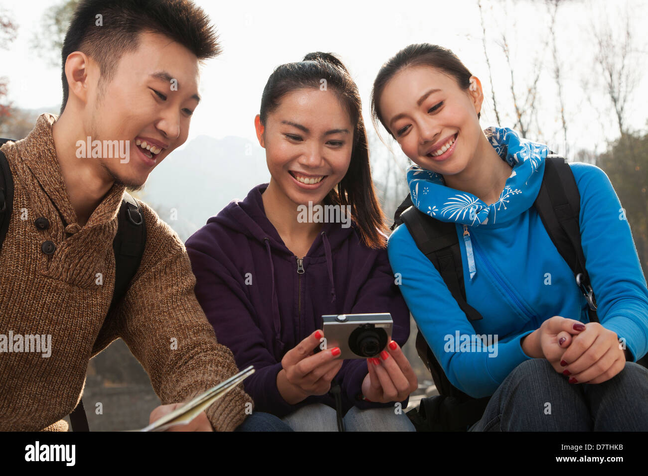 Friends looking at the picture on the screen of digital camera Stock Photo