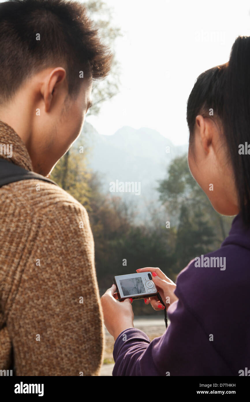 young couple looking at the picture on the screen of digital camera Stock Photo