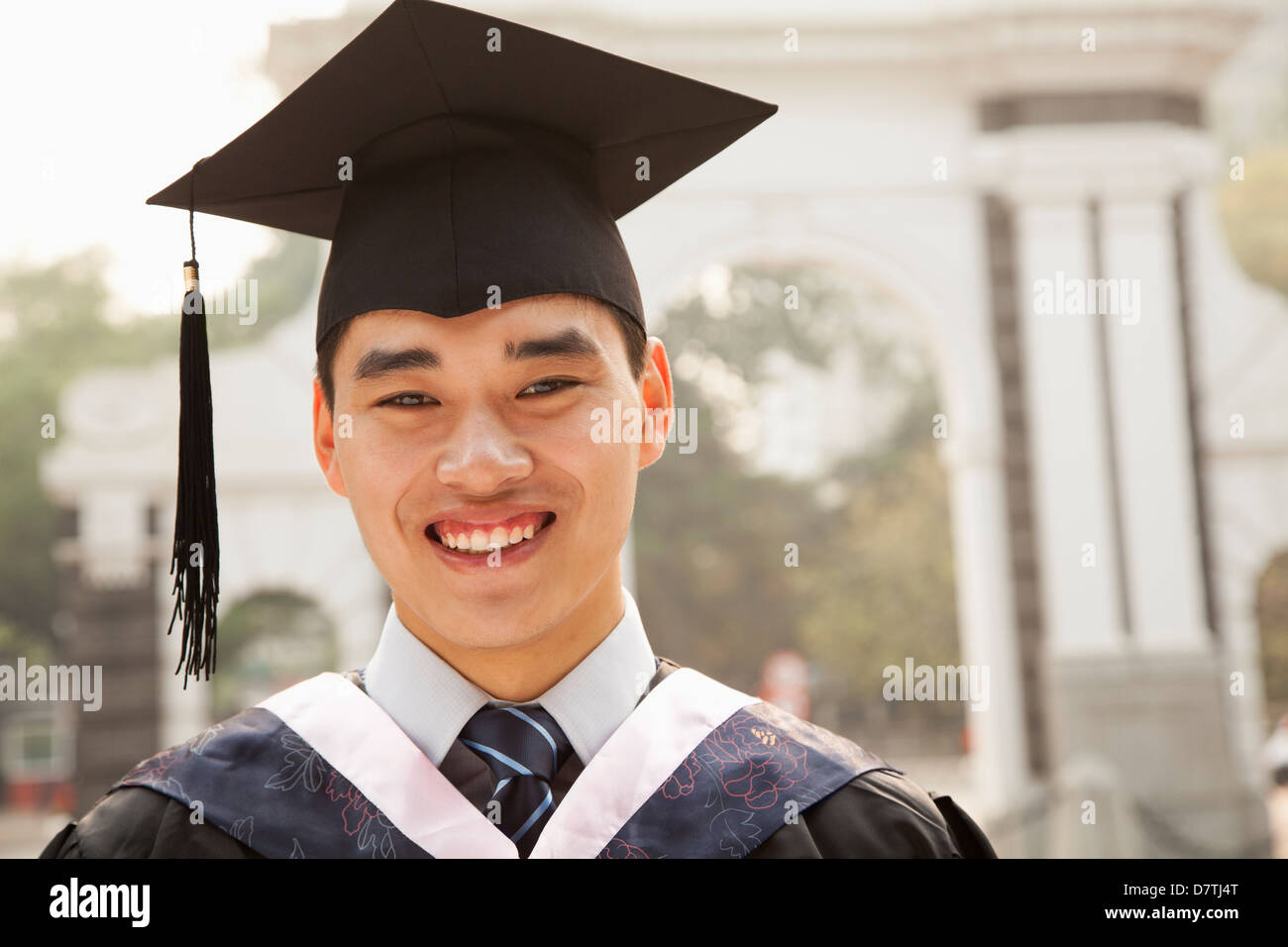 Graduate smiling in cap and gown hi-res stock photography and images ...