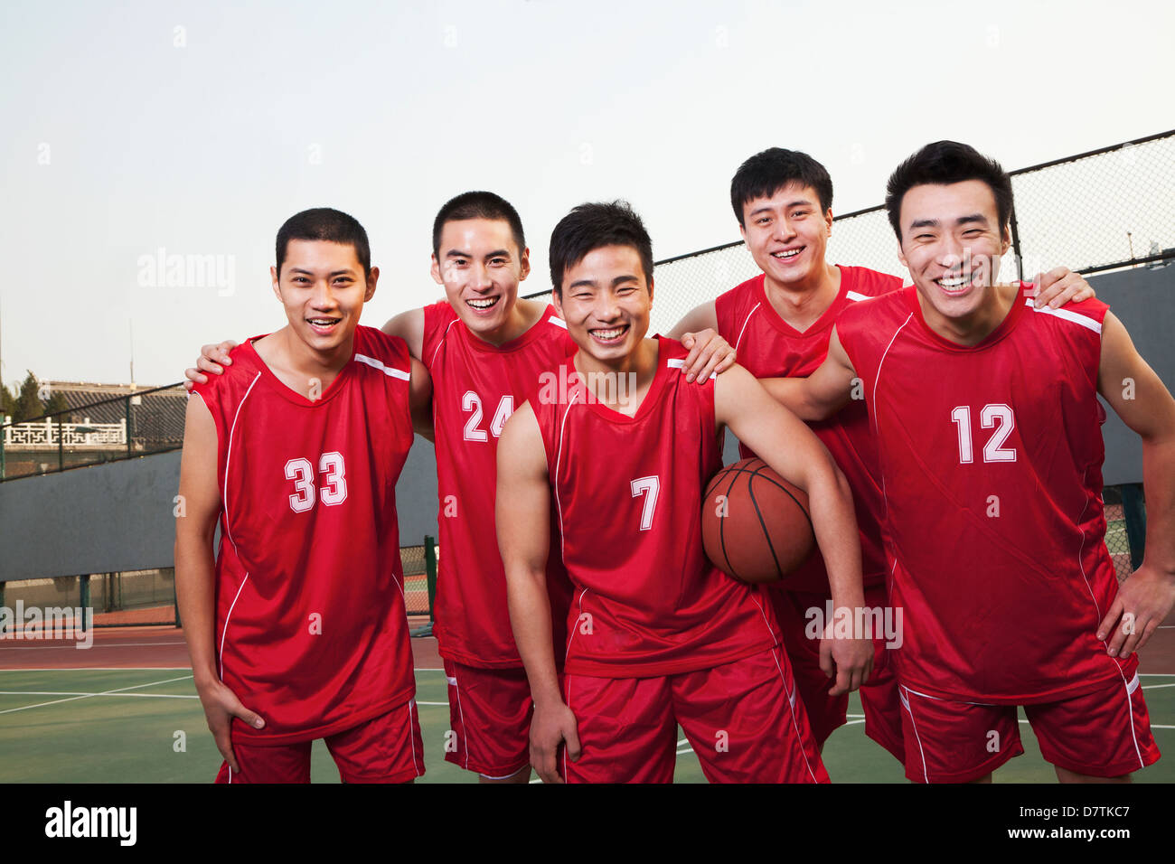 Basketball team standing and smiling, portrait Stock Photo Alamy
