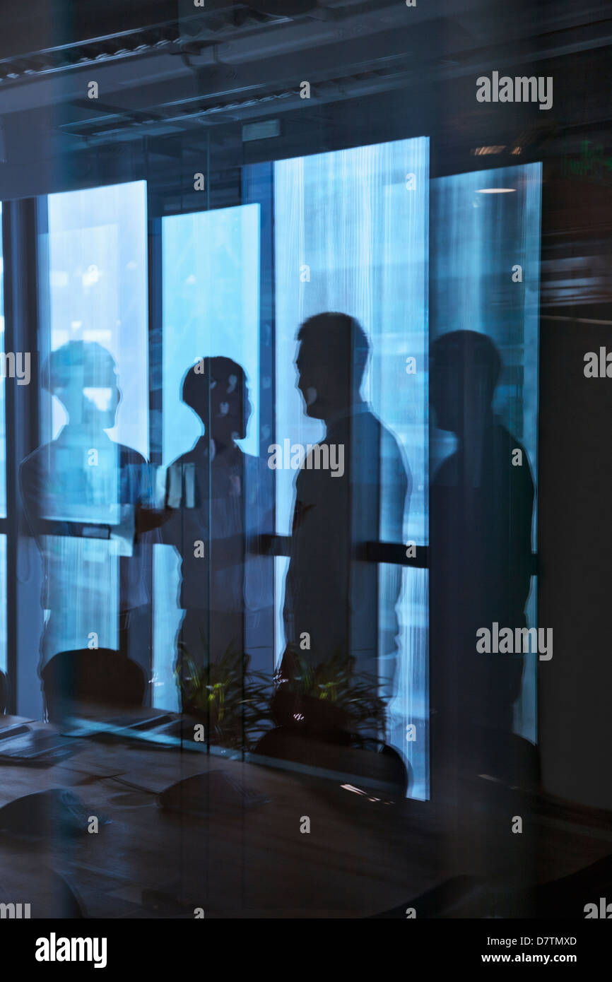 Reflection of two businessmen talking in the office Stock Photo