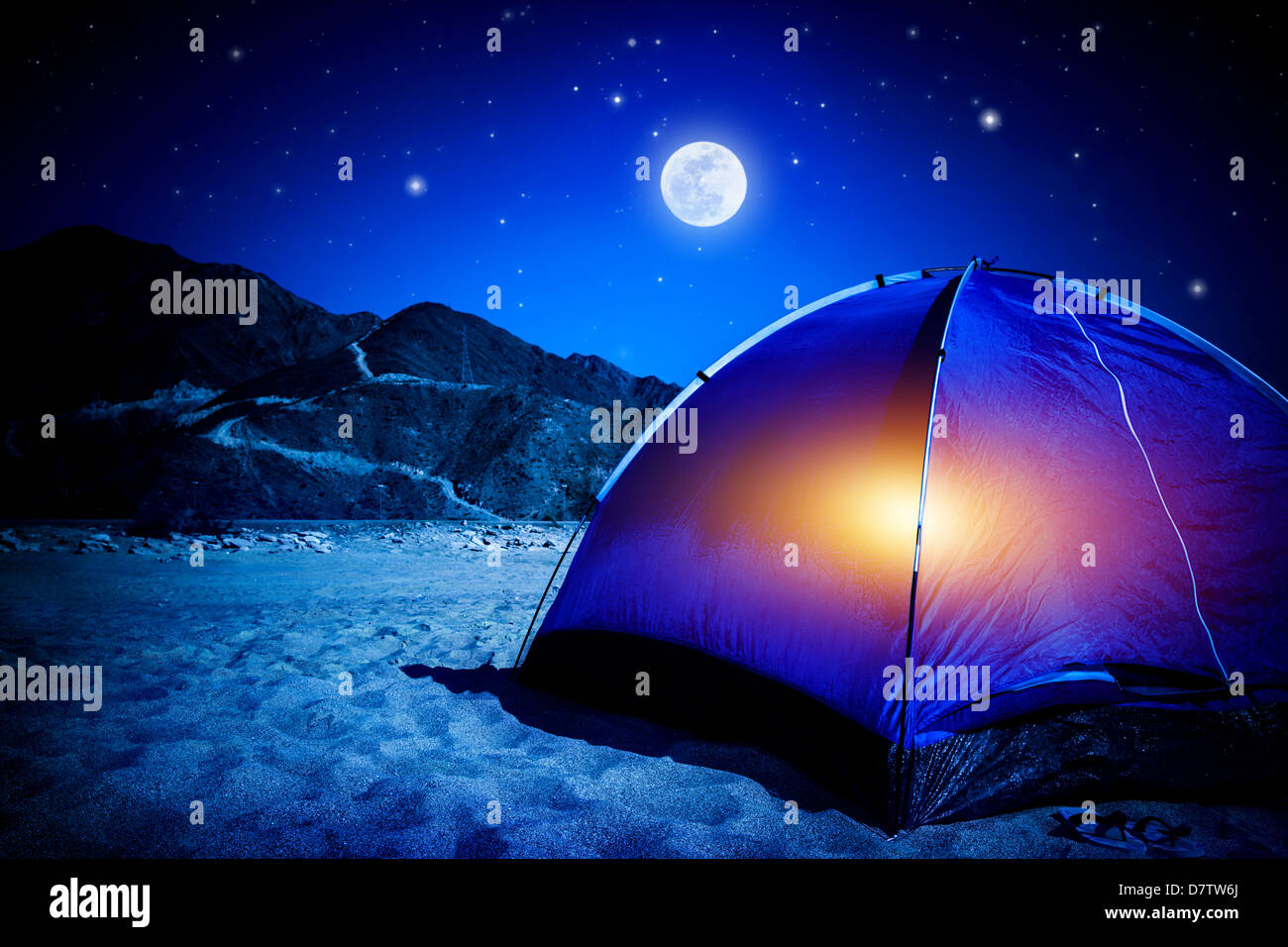 Camp on sandy beach, tent at the night with light inside, moon light, active tourism, hiking and traveling concept Stock Photo