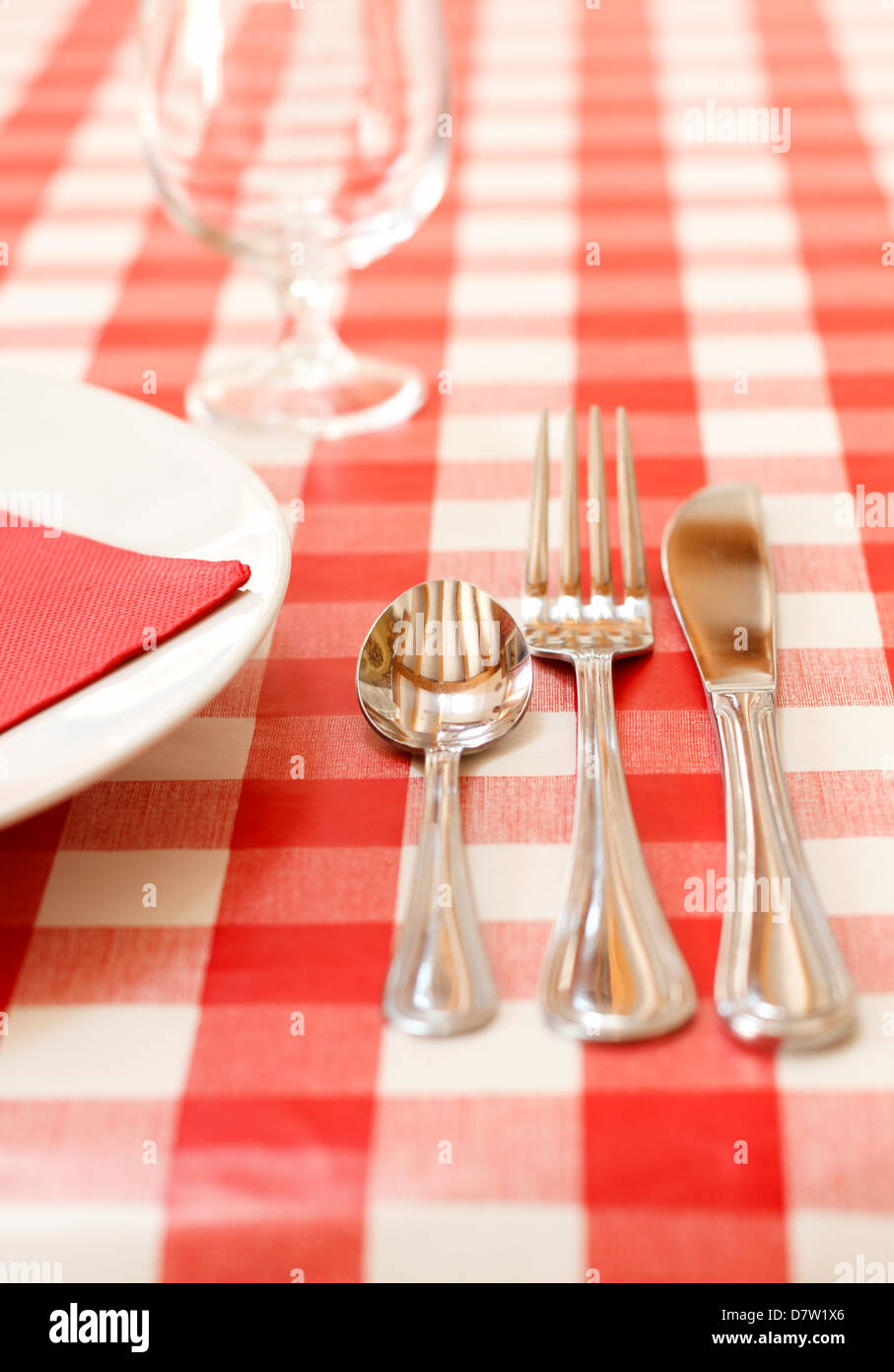 Red tablecloth with cutlery. Stock Photo