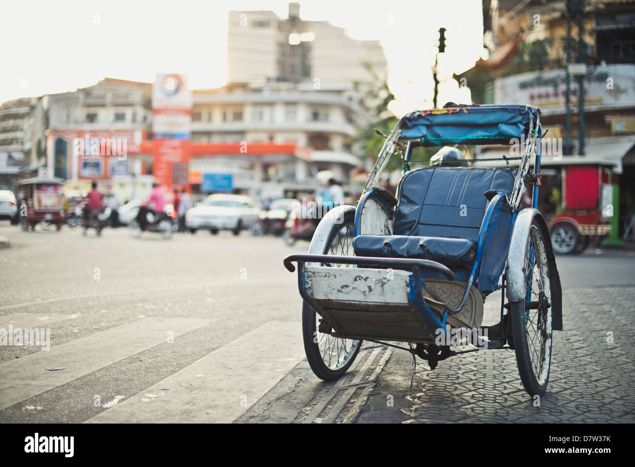 A cyclo parked on the side of the road, transportation in Cambodia Stock Photo