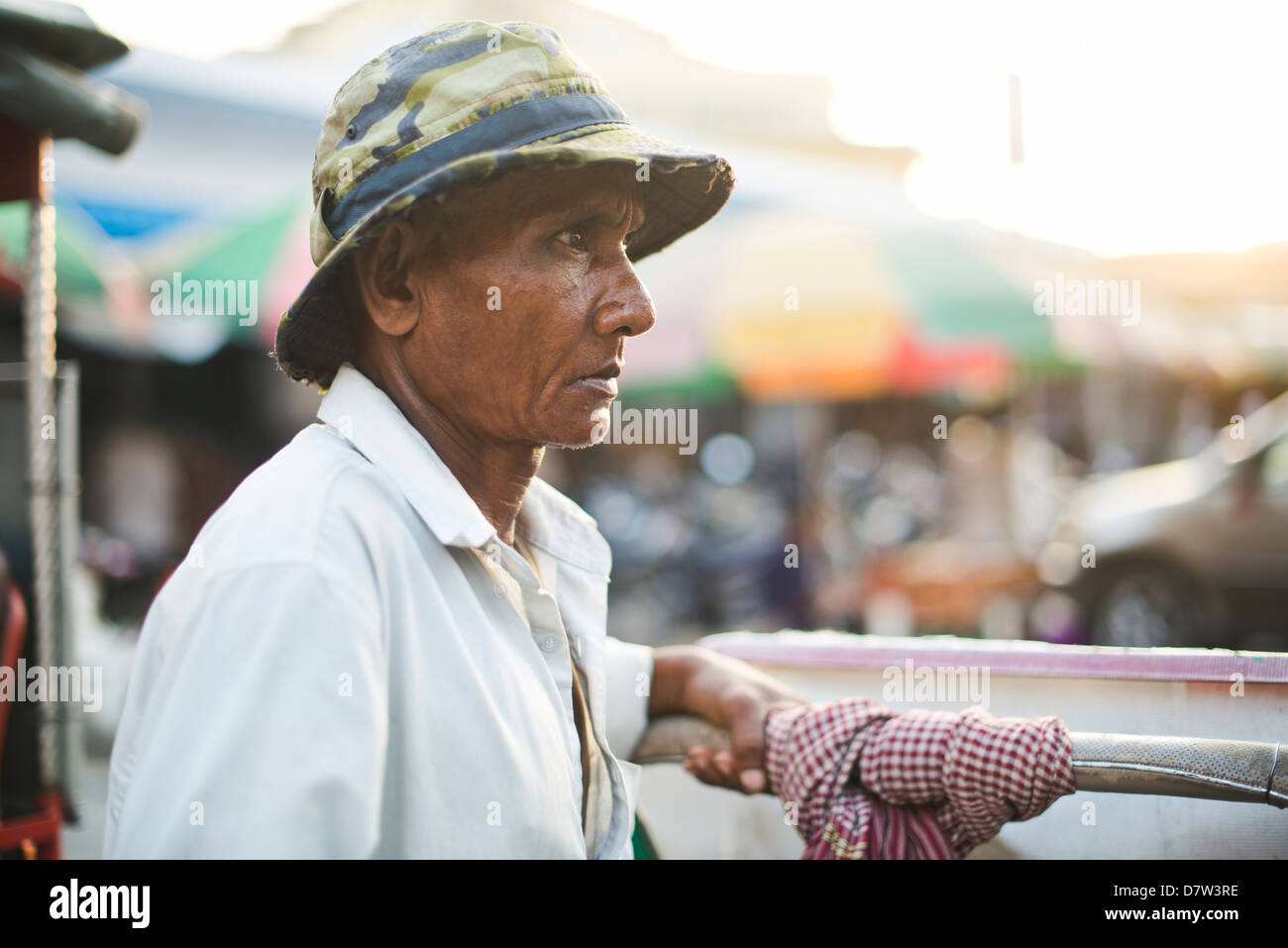 A cyclo driver awaits for customers, transportation in Cambodia Stock Photo
