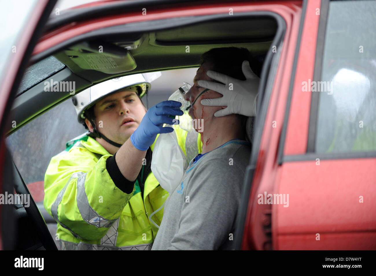 A road traffic accident (rta) victim is dealt with by an ambulance crew after a car crash. Stock Photo