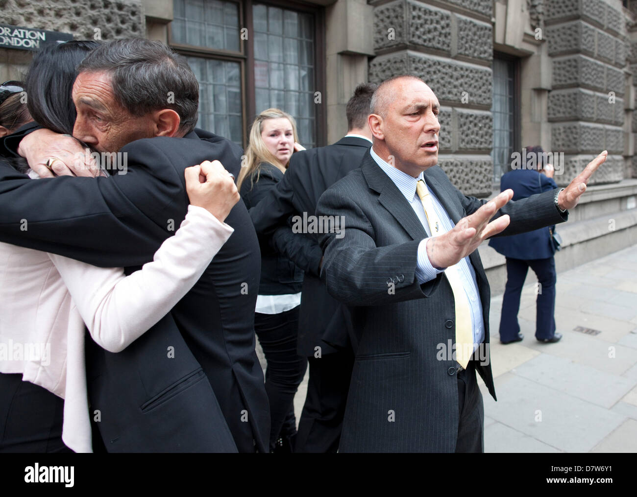 The Old Bailey, London, UK. 14.05.2013 Picture shows members of Steven Carter's family (far right with hands up) Stephen Carter, Grandfather of Tia,  leaving the Old Bailey after Stuart Hazell was jailed for life with a minimum term of 38 years after finally admitting the murder of schoolgirl Tia Sharp. Stock Photo