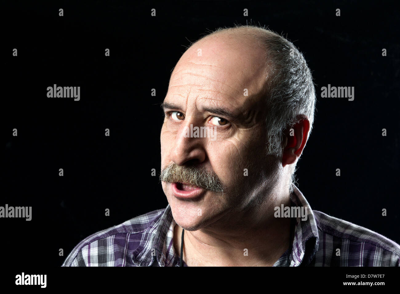 Very angry bald man with a big mustache Stock Photo