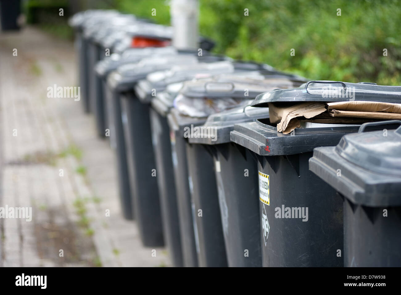 A row of grey wheelie bins full of carbage Stock Photo Alamy