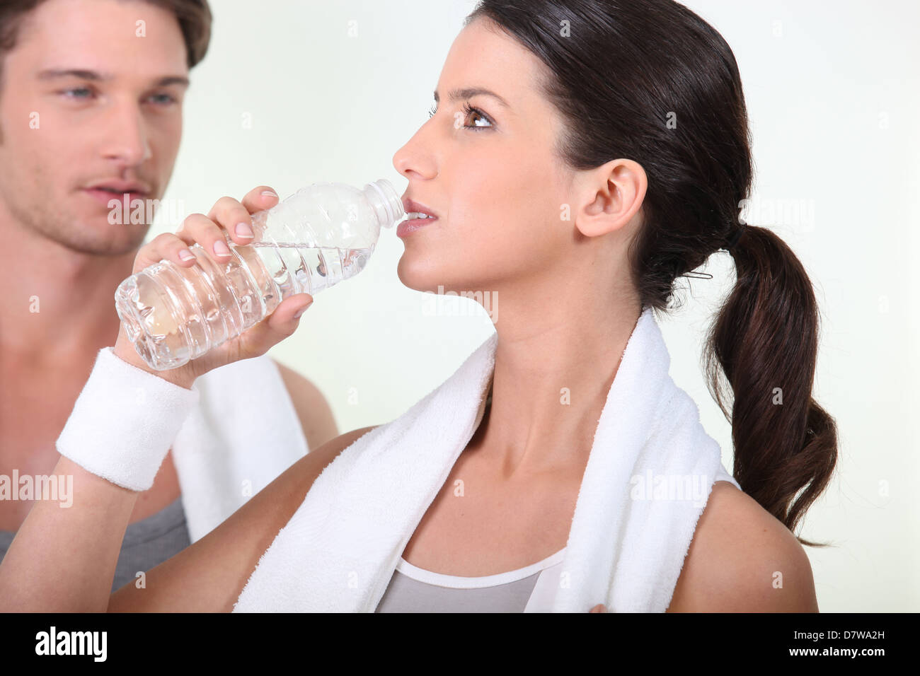 Woman drinking after a workout Stock Photo
