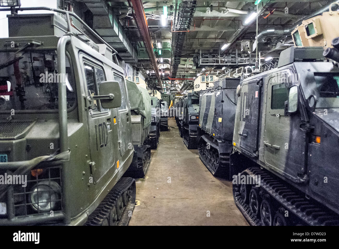 The Vehicle Deck onboard Assault Ship HMS Bulwark with Viking and BV personnel carrier vehicles of the Royal marines. Stock Photo