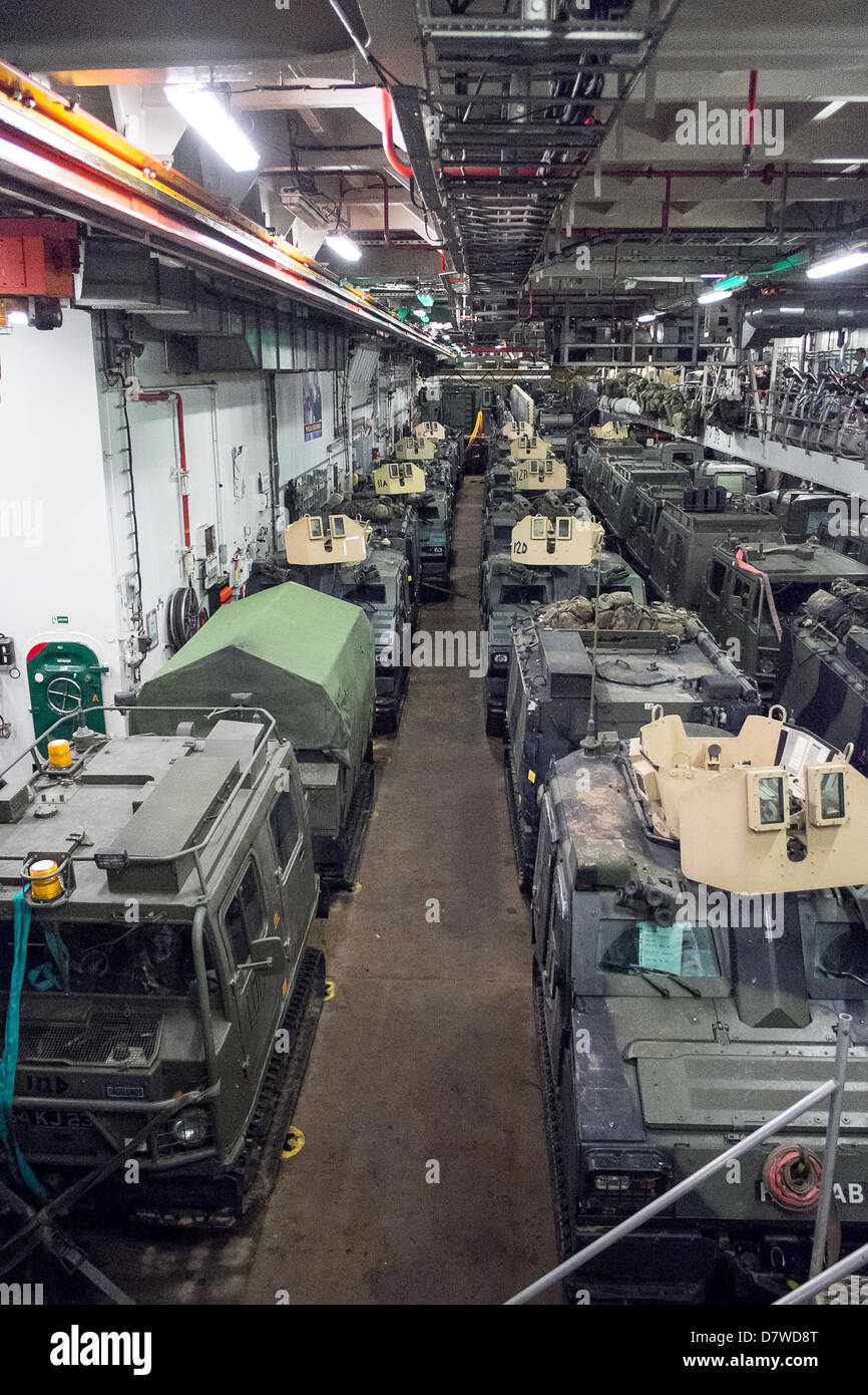 The Vehicle Deck onboard Assault Ship HMS Bulwark with Viking and BV personnel carrier vehicles of the Royal marines. Stock Photo