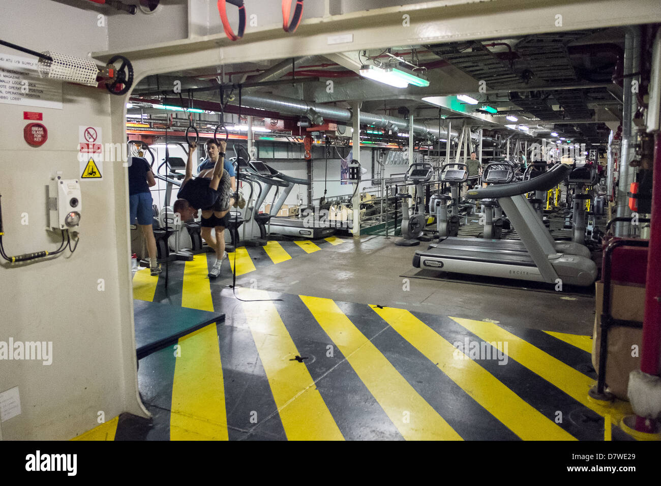 Part of the vehicle deck is used as fitness facilities onboard Royal Navy Assault Ship HMS Bulwark Stock Photo