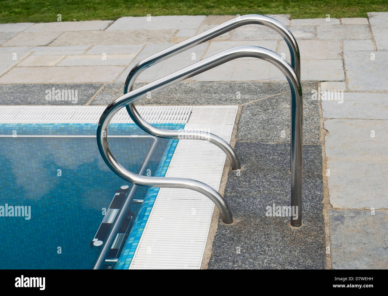 Swimming pool edge with steel handle bars Stock Photo