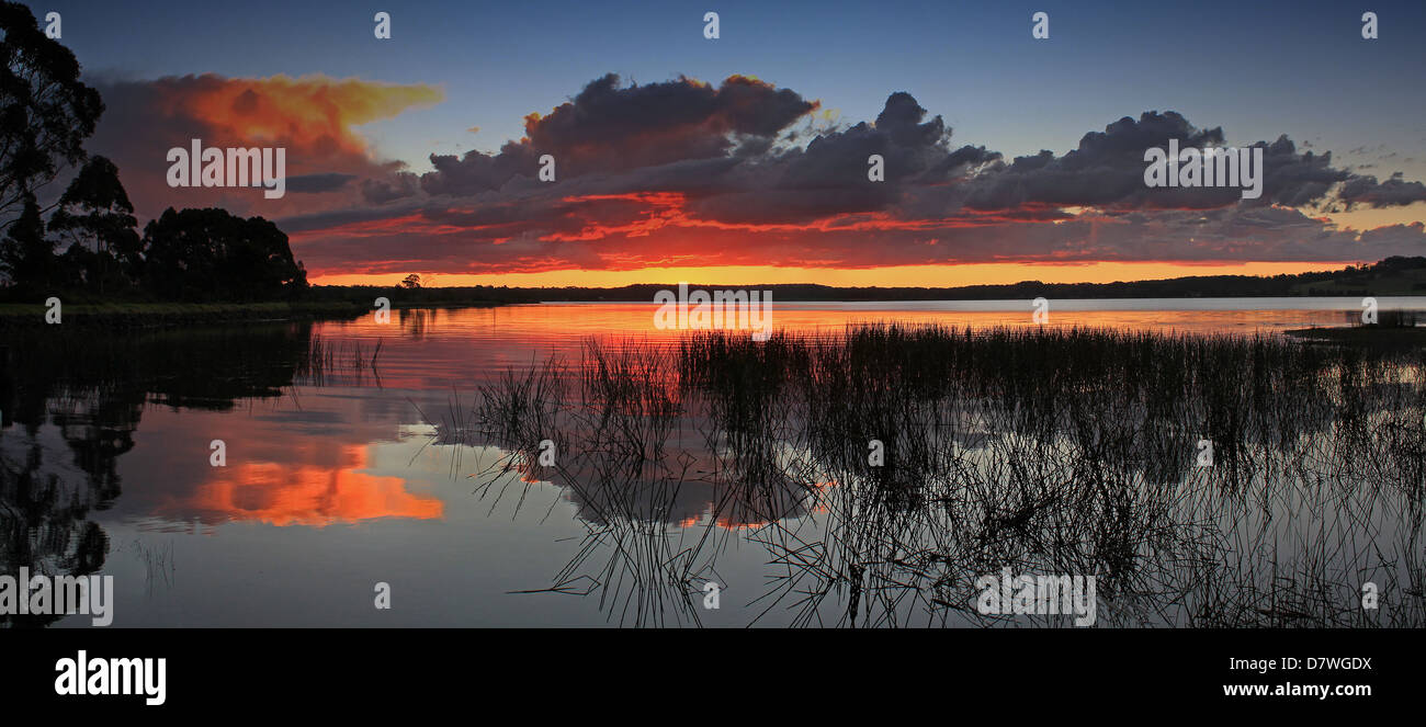 Panoramic view of Sunset with dramatic clouds over water Stock Photo