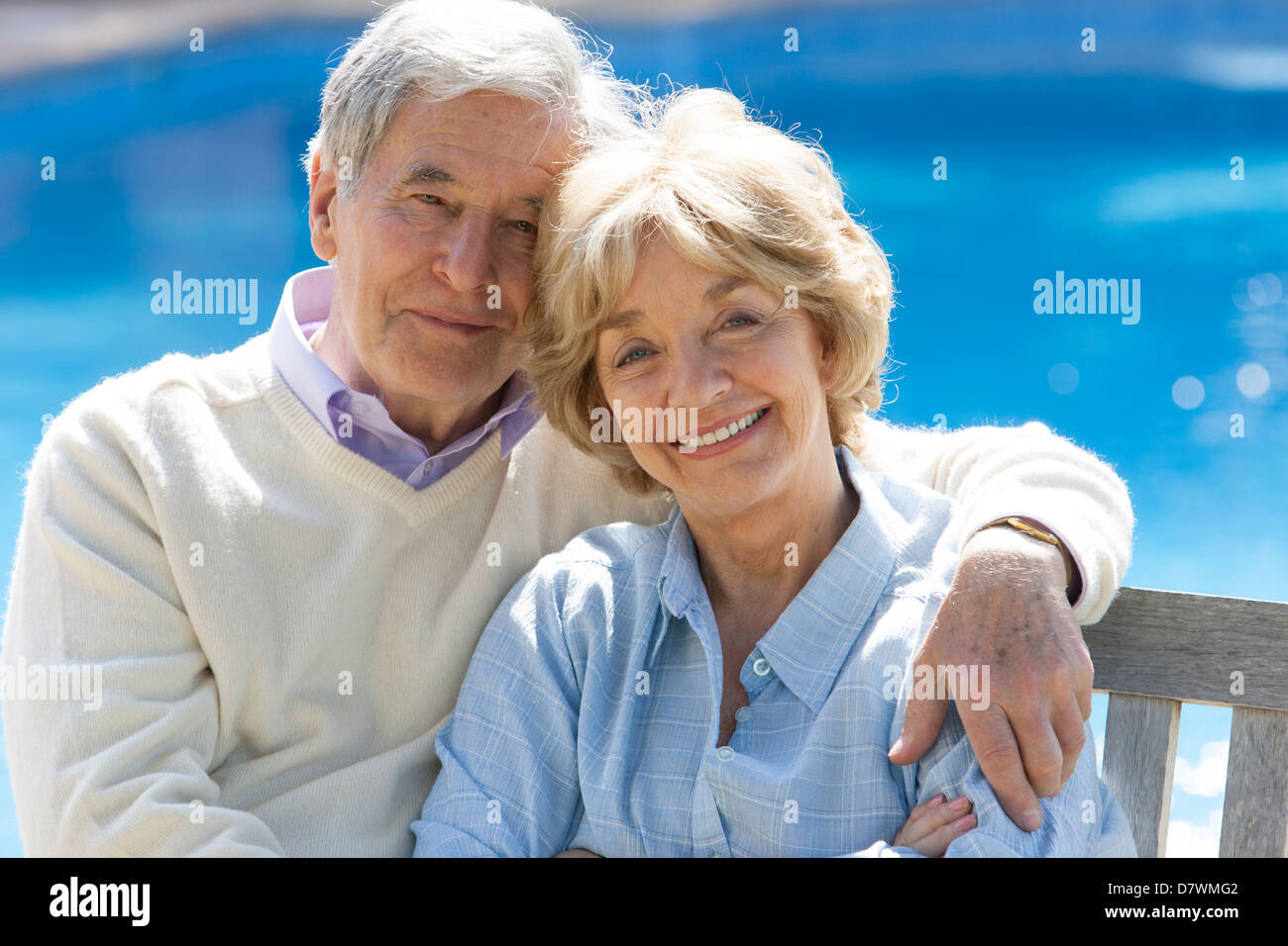 Elderly couple sitting by their pool Stock Photo - Alamy