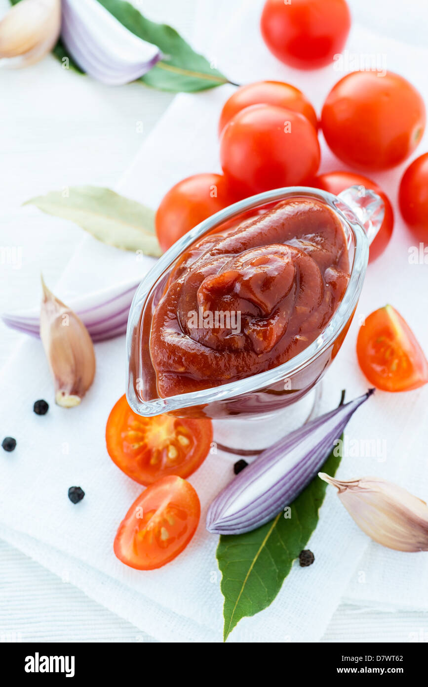 traditional-homemade-tomato-sauce-with-ingredients-on-light-background